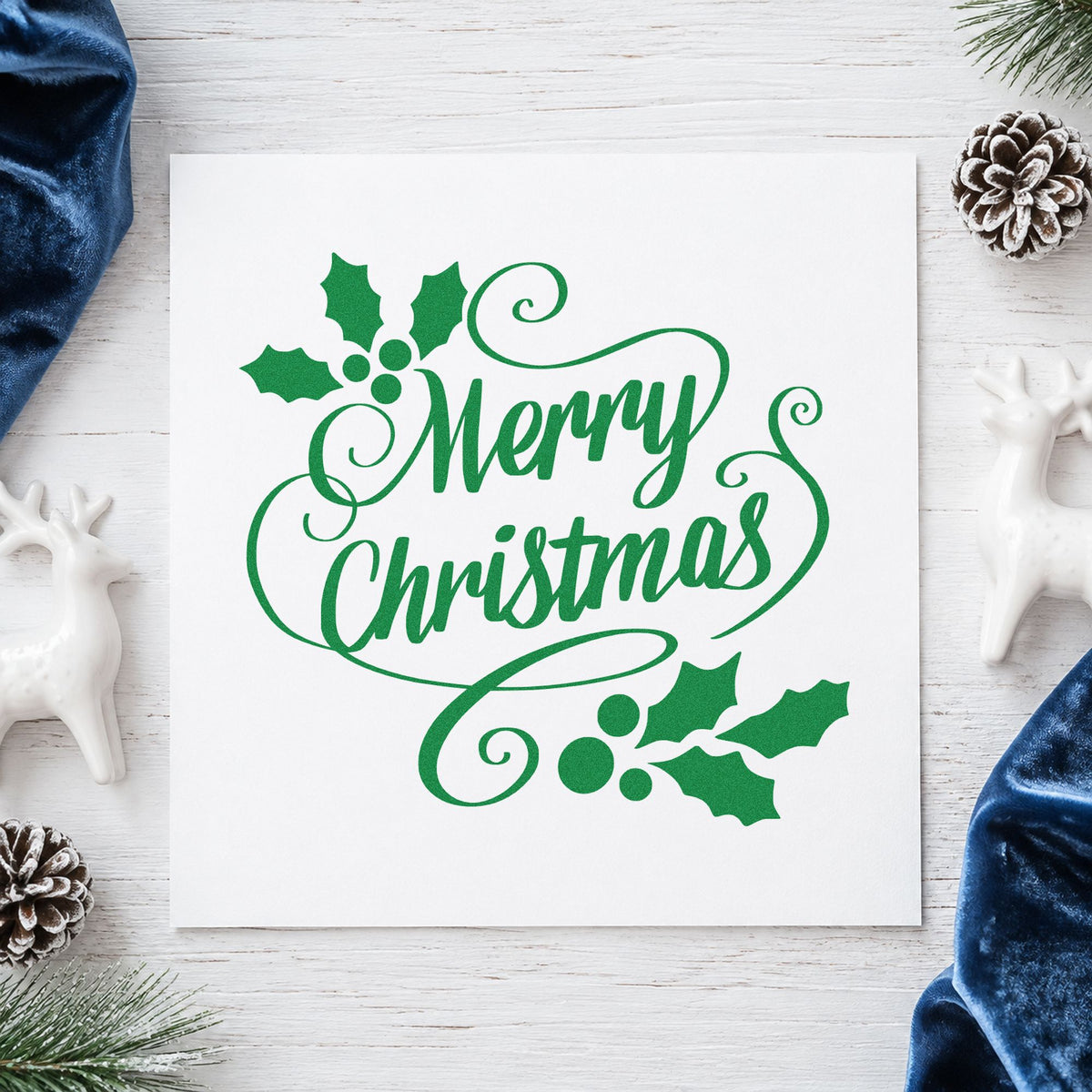Merry Christmas Holly Flourishes craft stamp imprint in green ink on a handmade project, one idea being velvet ribbon tags.