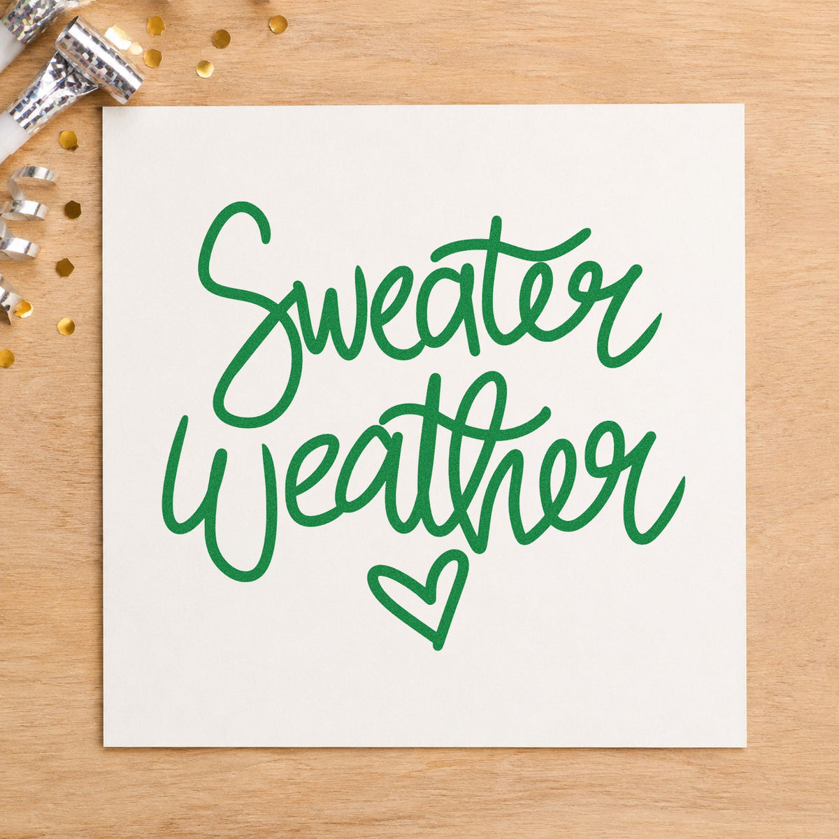 Sweater Weather Little Heart craft stamp imprint in green ink on a handmade project, one idea being knit care gift tags.