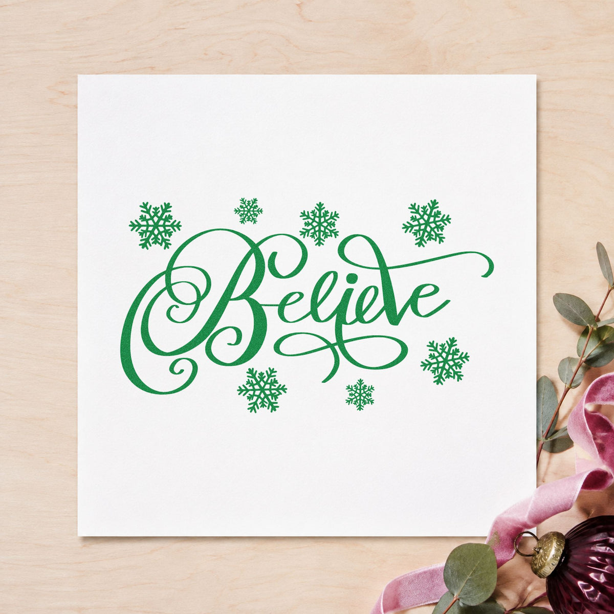 Believe Surrounded By Snowflakes craft stamp imprinted in green ink on paper, a design suited to framed frosted window.