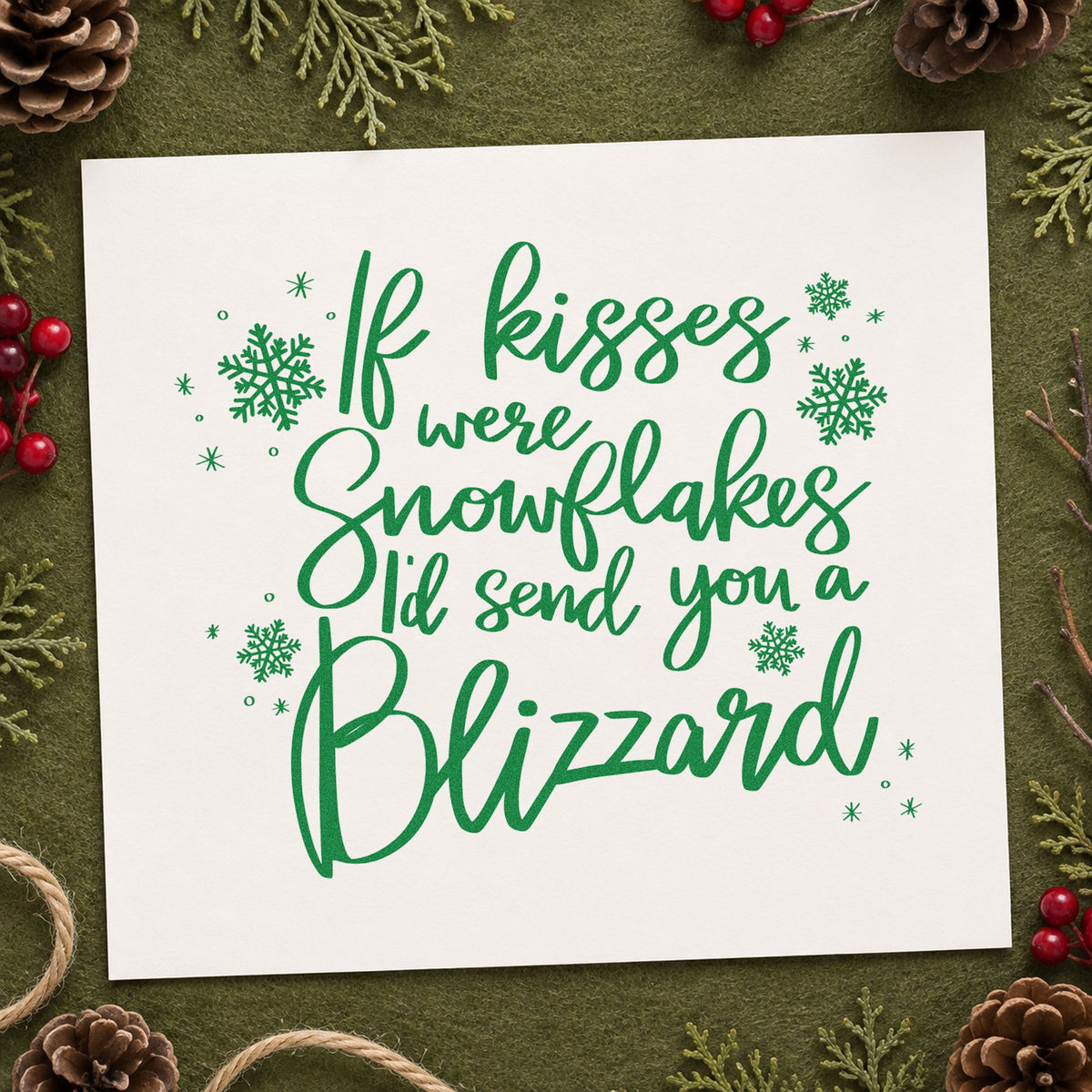 Kisses Snowflakes Blizzard Quote craft stamp imprint in green ink on a handmade project, one idea being care parcel tags.