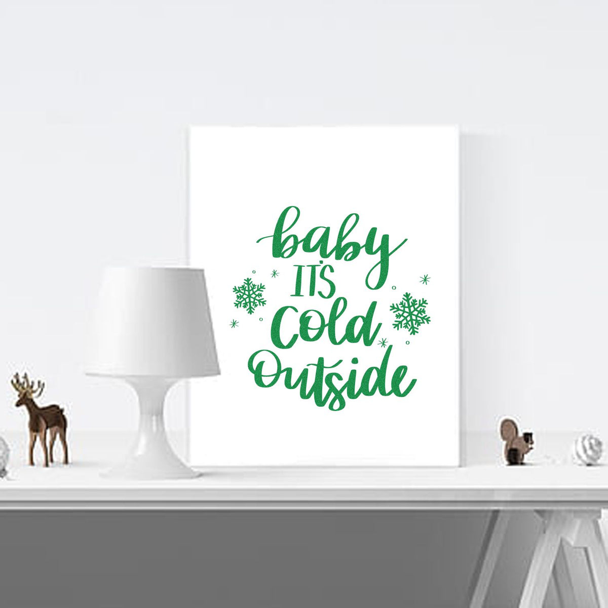 Green Baby Its Cold Outside Christmas stamp and seal design with snowflakes on a white background.