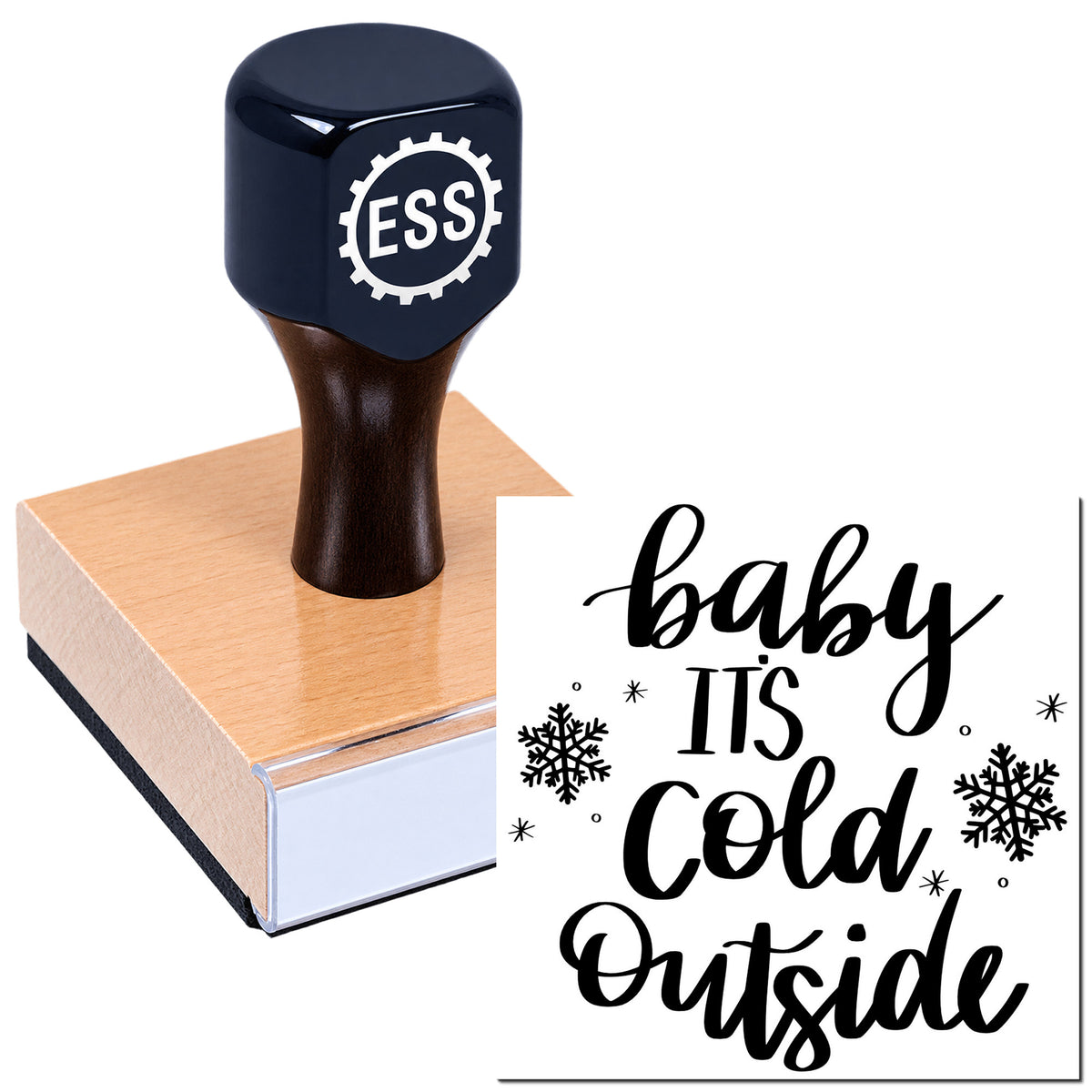 Black ESS stamp seal on a wooden block, printing "baby it's cold outside" in black with snowflakes.