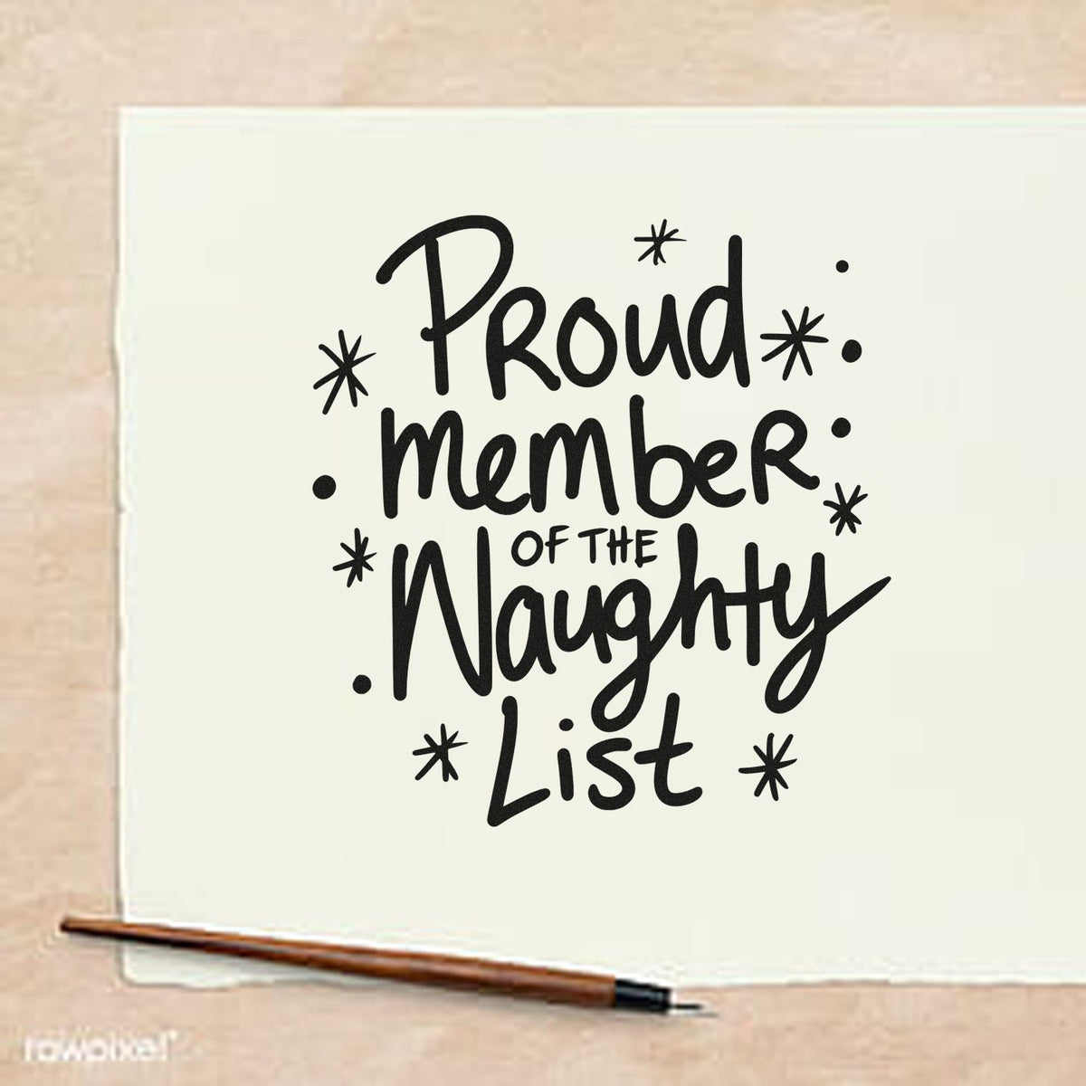 Black holiday stamp and seal reading Proud Member of the Naughty List on white paper, with a brown pen on beige background.