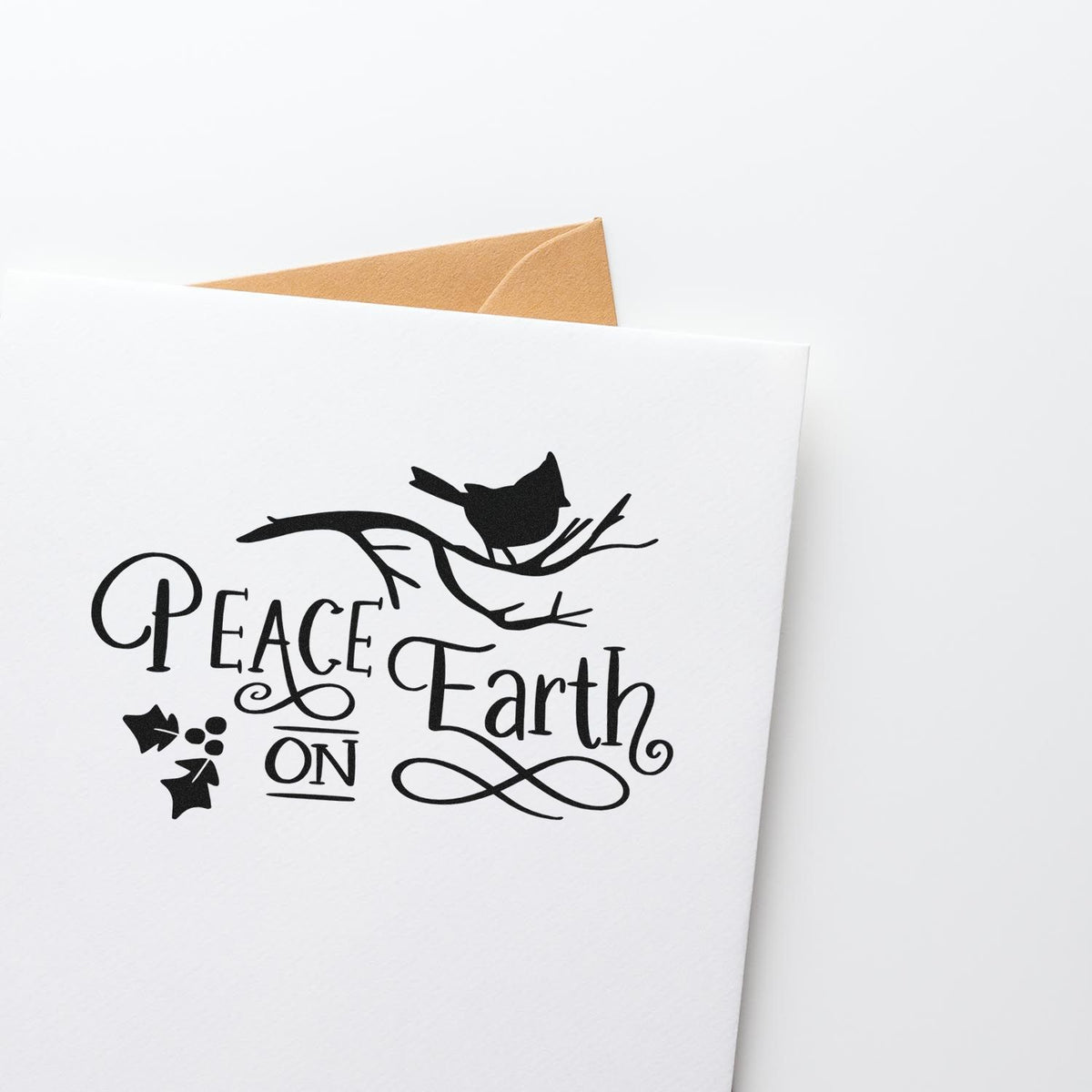 Black Peace Earth On stamp with bird on branch on a white card, with tan envelope behind.