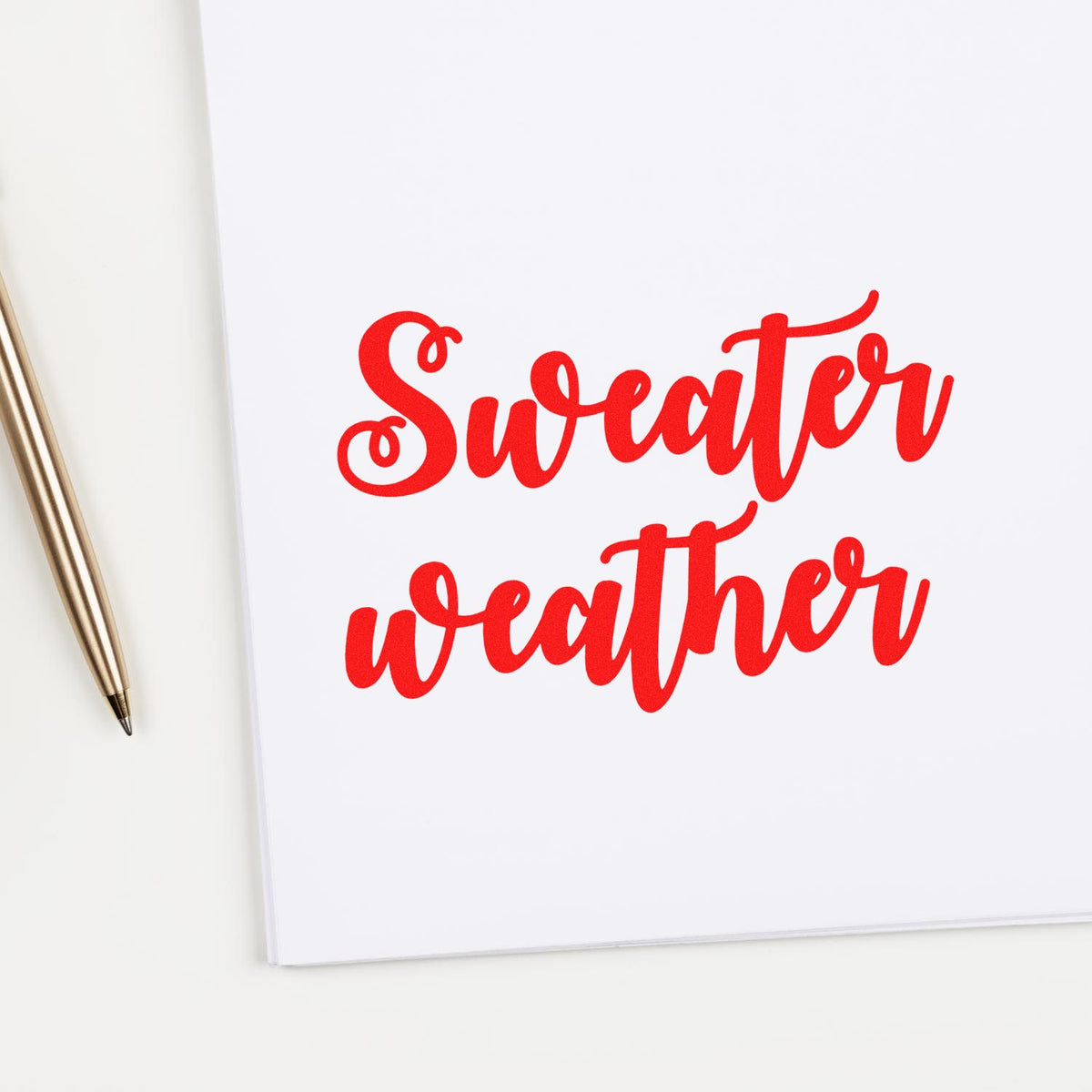 Sweater Weather Brush Script rubber stamp shown in red ink, stamped for projects such as bold album header.