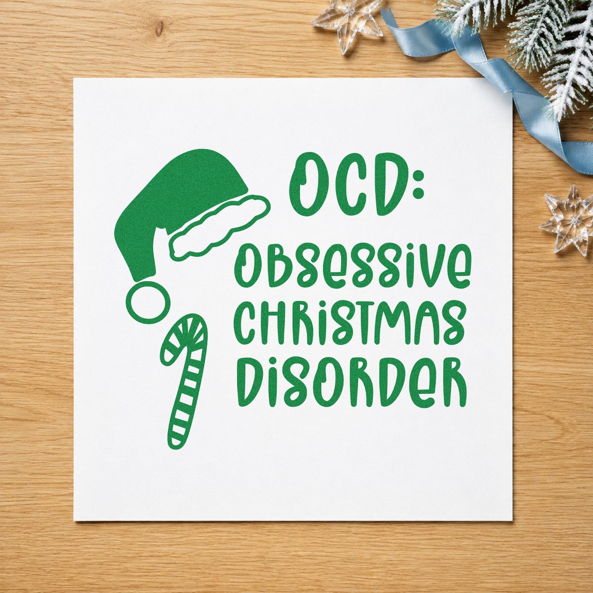 Obsessive Christmas Disorder Hat craft stamp imprinted in green ink on paper, a design suited to framed craft room.