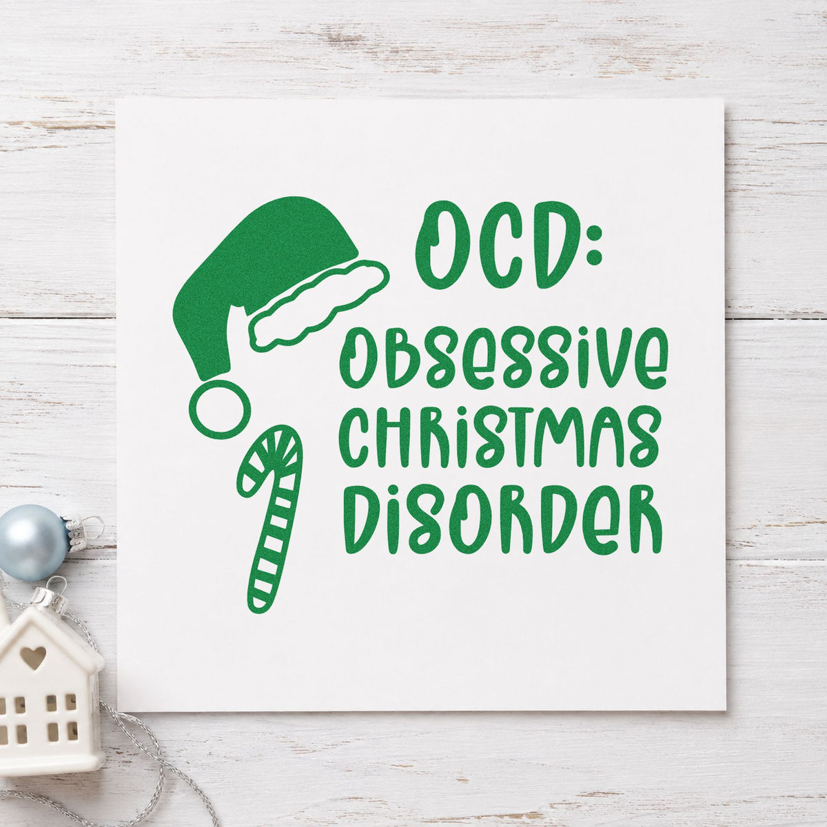 Obsessive Christmas Disorder Hat craft stamp imprint in green ink on a handmade project, one idea being swap meet cards.