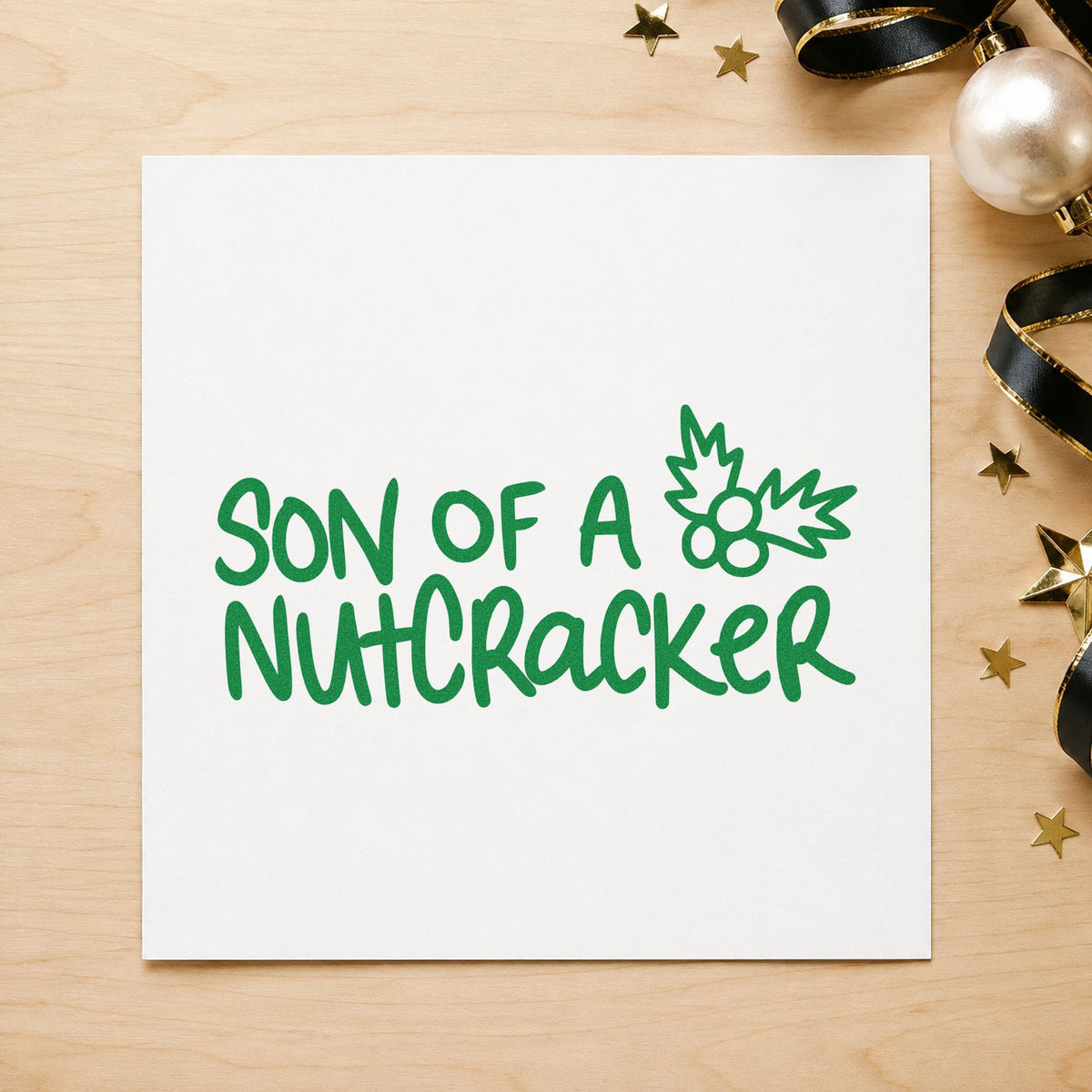 Son Of A Nutcracker craft stamp imprint in green ink on a handmade project, one idea being ballet ticket tags.