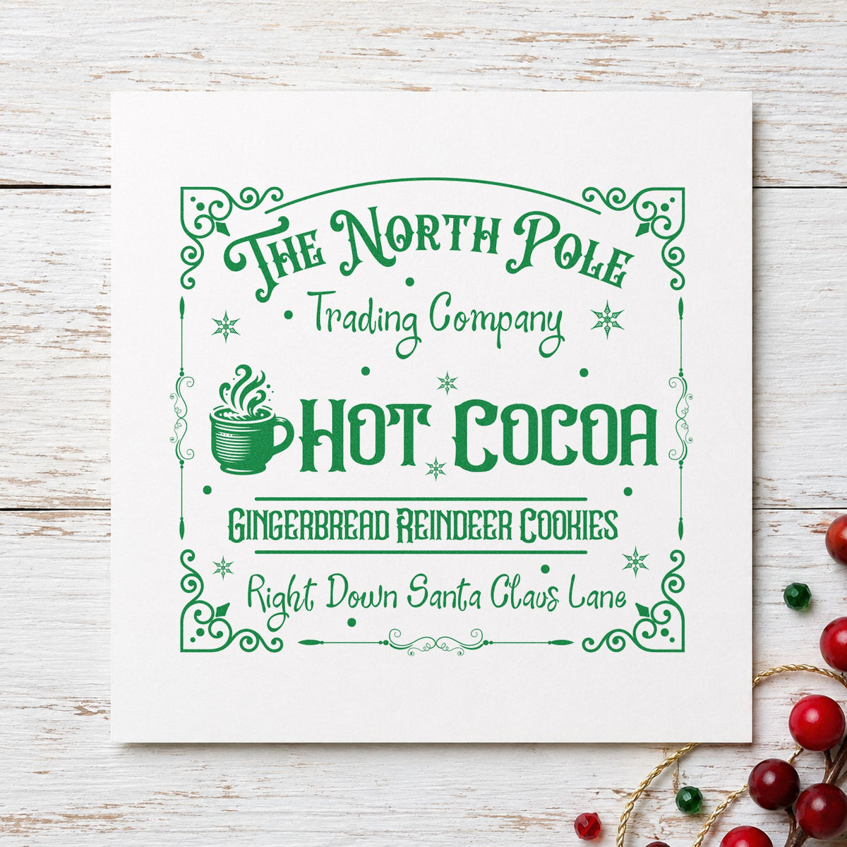 North Pole Trading Hot Cocoa craft stamp in green ink on cardstock, an easy option for counter album page.