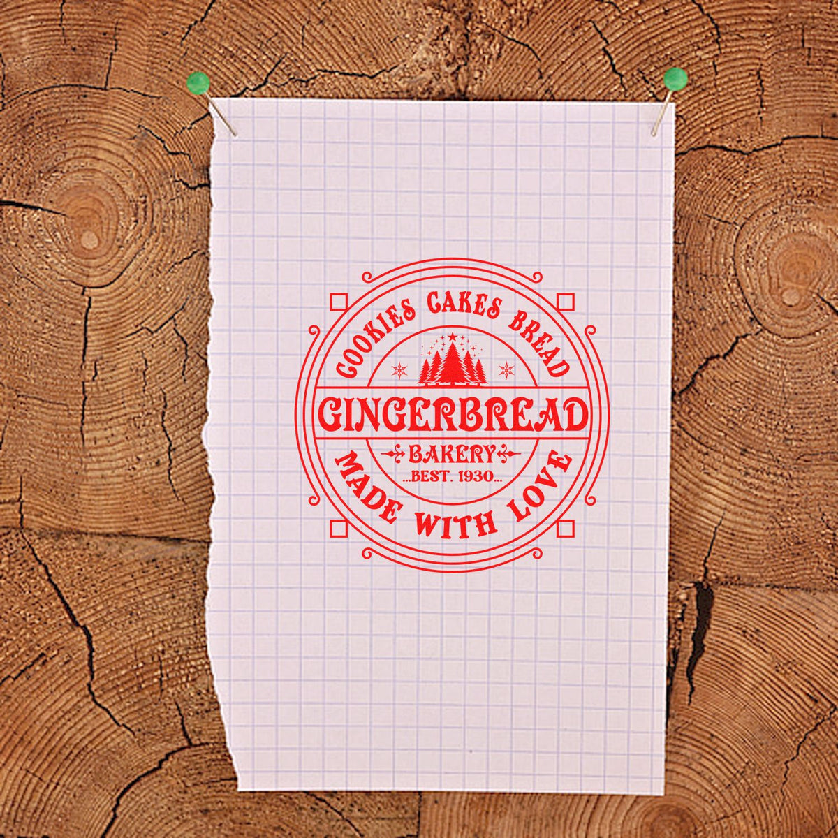 Red circular gingerbread bakery stamp and seal in bright red on white graph paper, pinned over rustic wood background.