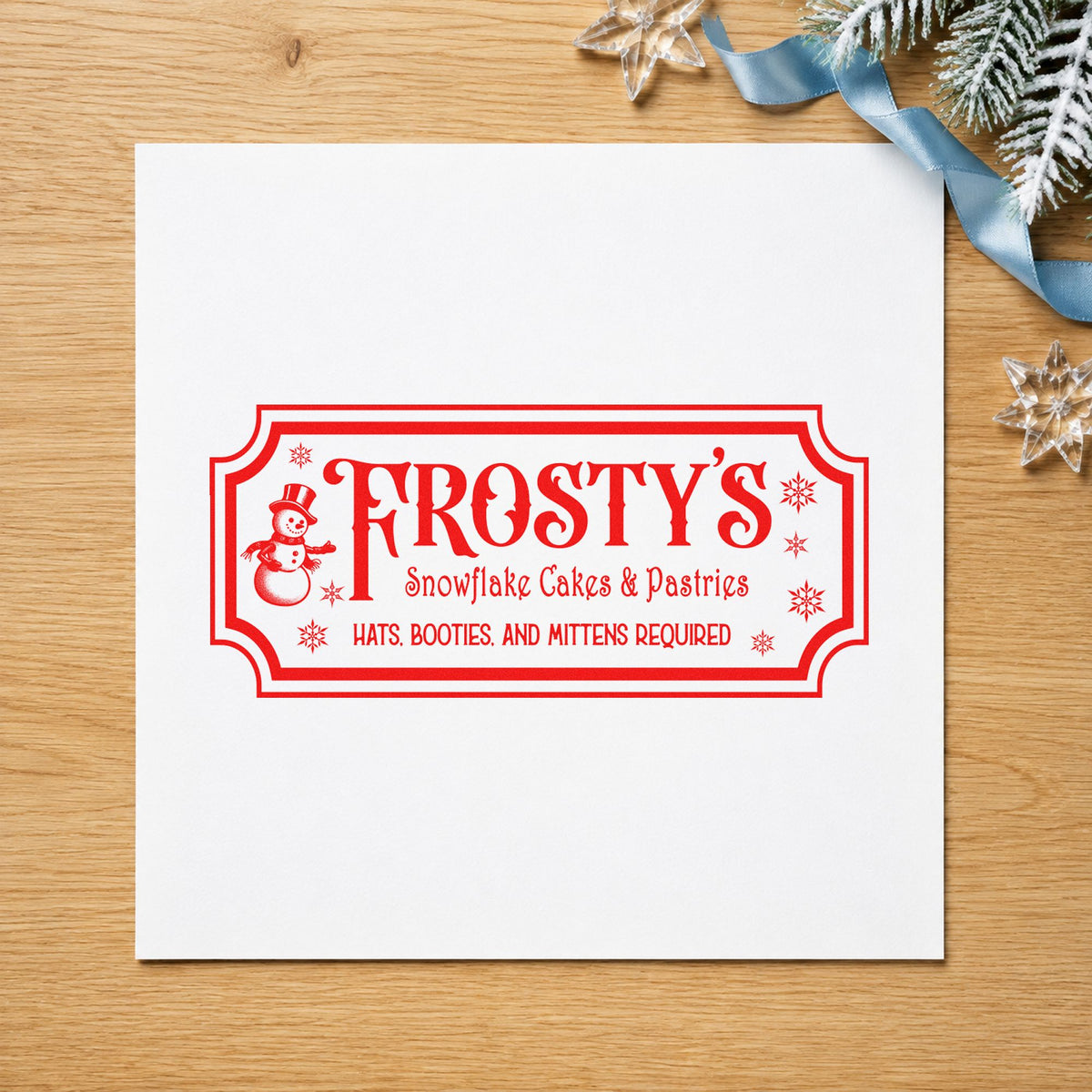 Frosty's Snowflake Cafe Pastries craft stamp in red ink on cardstock, an easy option for server apron printing.