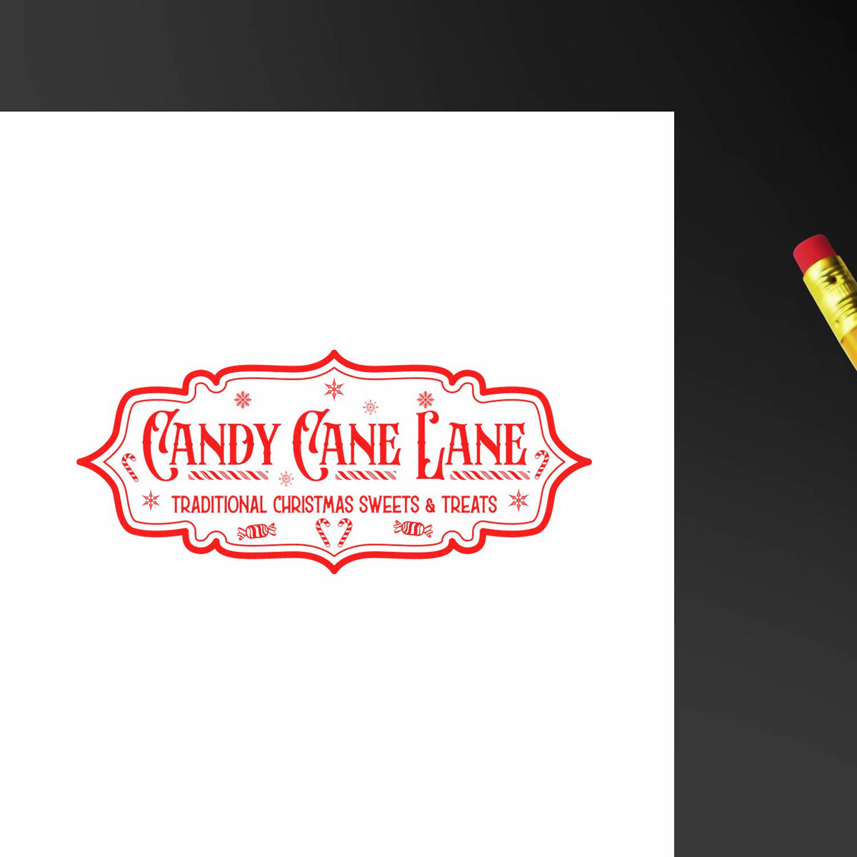 Red Candy Cane Lane holiday stamp seal with snowflakes and candy cane accents on white paper, beside a gold pencil.