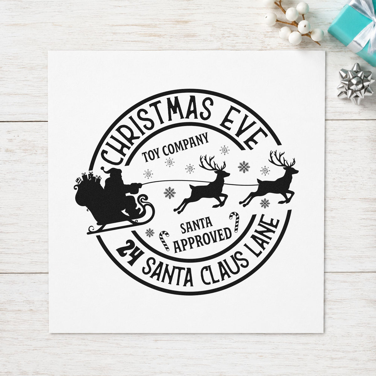 Christmas Eve Toy Company craft stamp imprint in black ink on a handmade project, one idea being toy box tags.