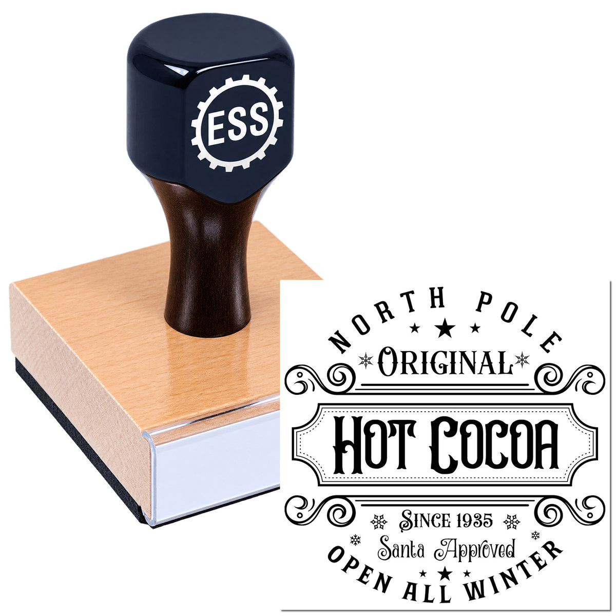Dark navy ESS rubber stamp on a pink pad beside a black-and-white holiday seal reading North Pole Original Hot Cocoa