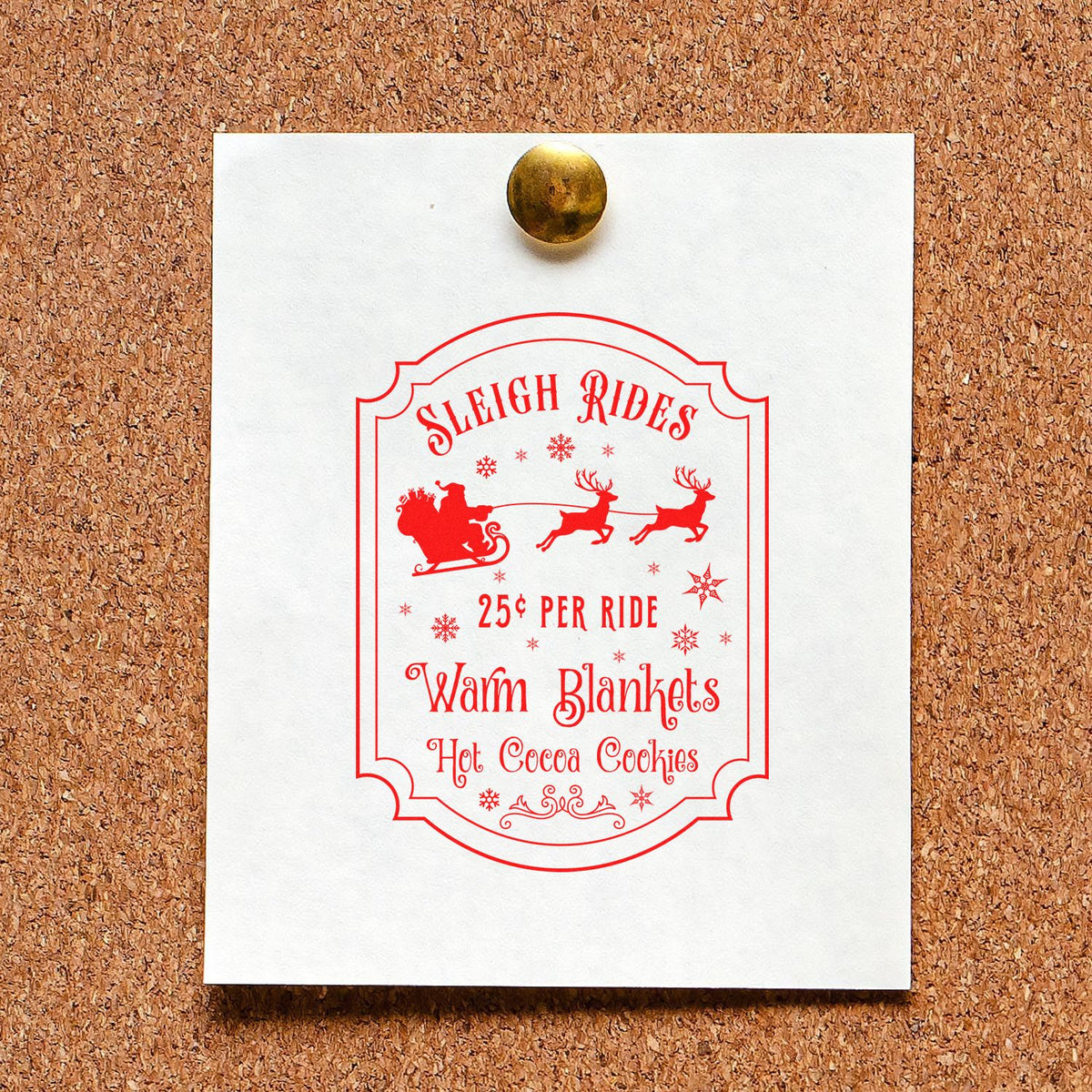 White card on corkboard with red holiday stamp seal, sleigh and reindeer, Sleigh Rides, gold pushpin.