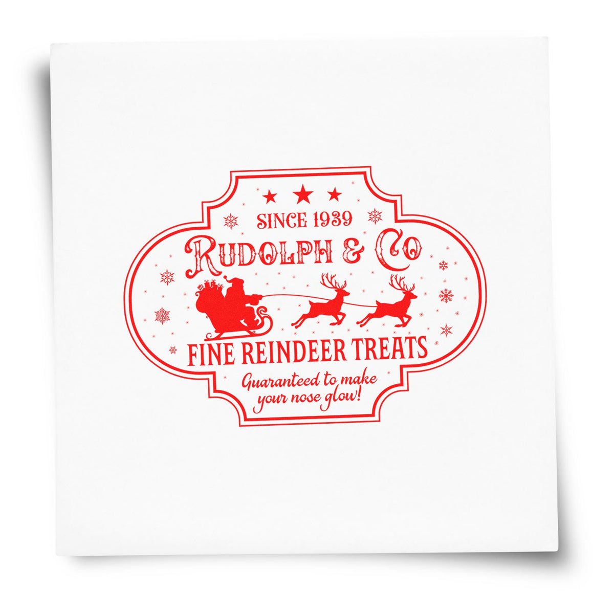 Red vintage stamp seal on white package featuring Rudolph & Co, Santa sleigh, reindeer, and snowflakes.