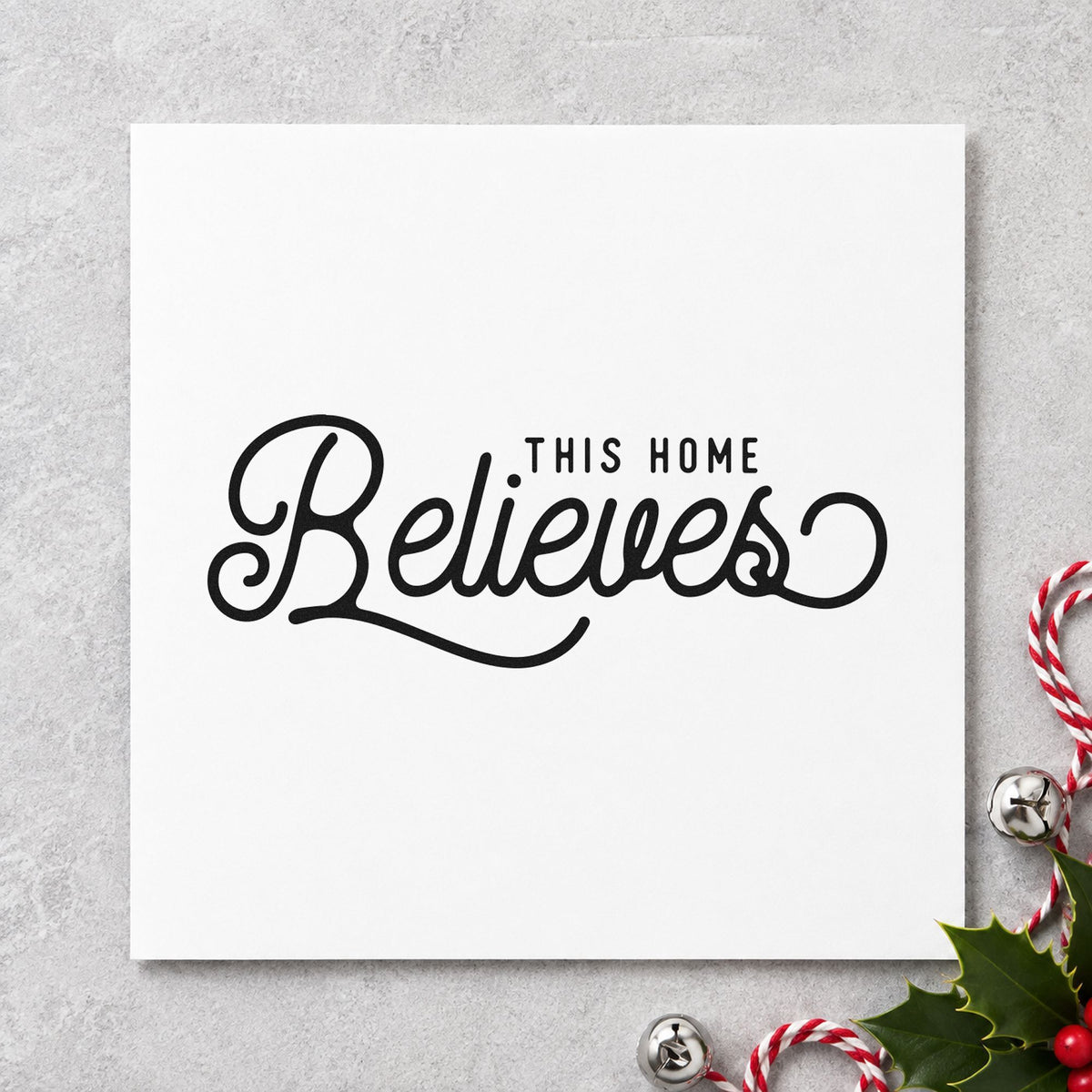 This Home Believes Script craft stamp imprint in black ink on a handmade project, one idea being door hanger tags.