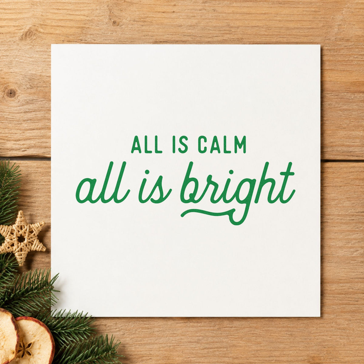 All Calm All Bright Script craft stamp imprint in green ink on a handmade project, one idea being vigil program cards.