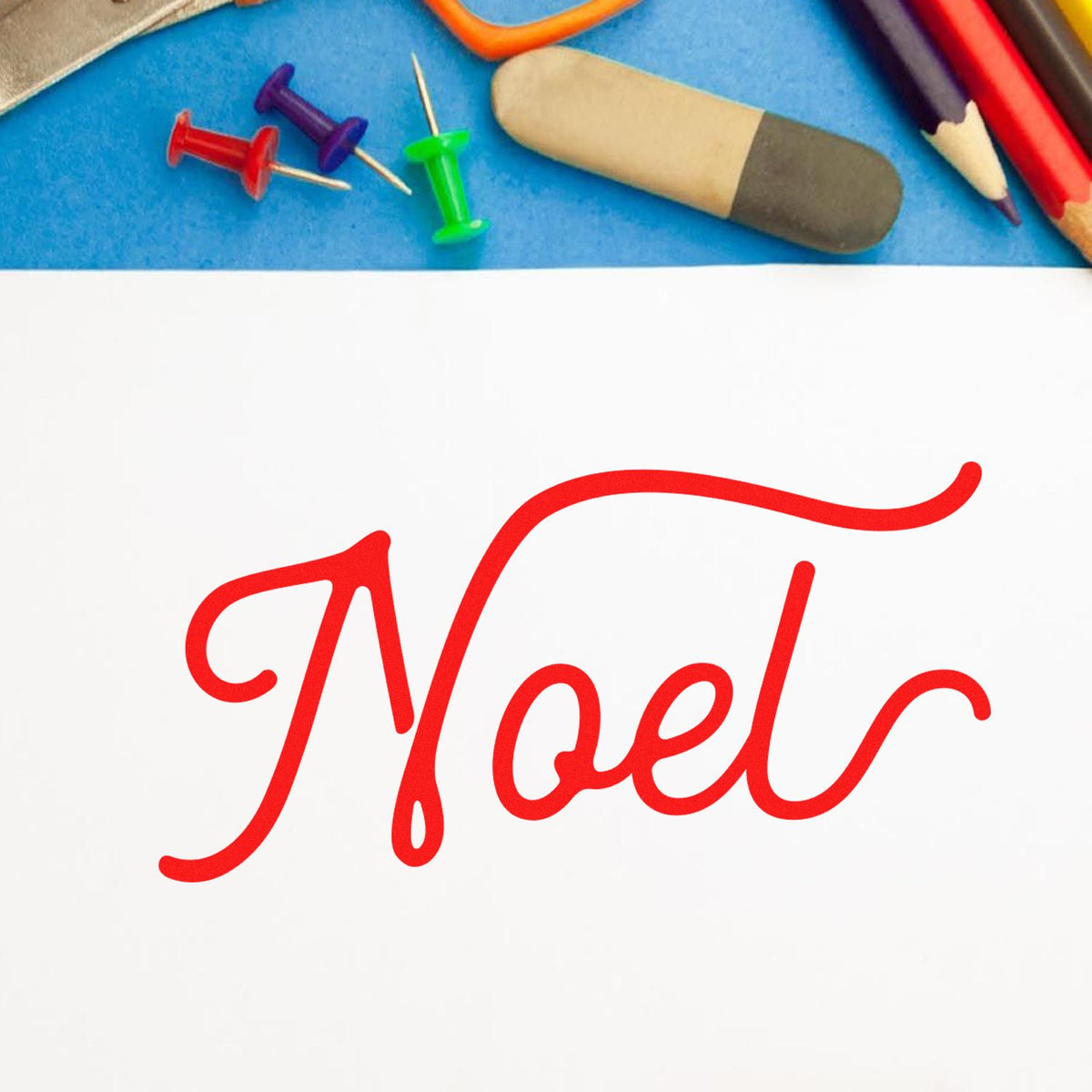 Red Noel script on white paper, with colorful pushpins, eraser, and pencils above, highlighting stamp and seal products.