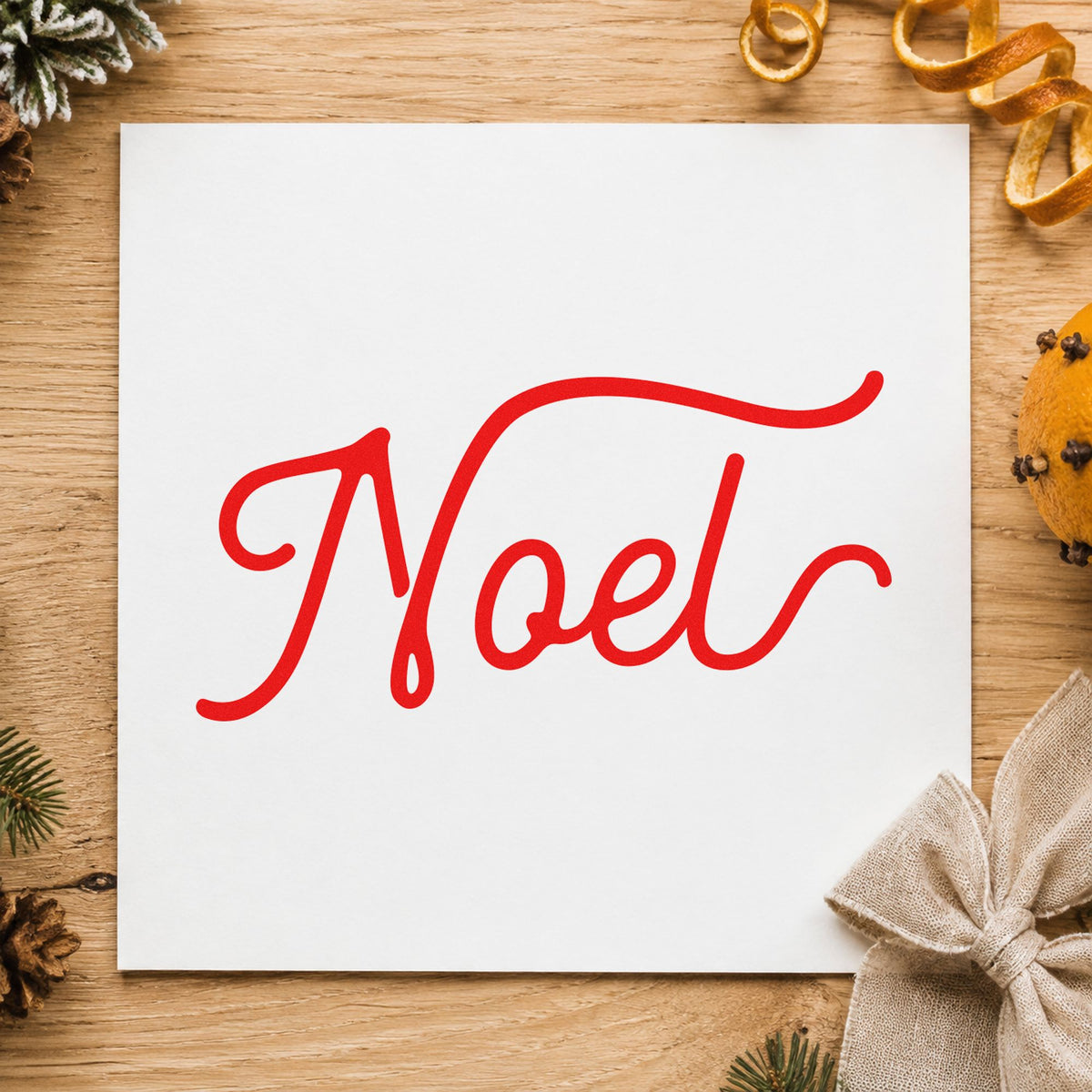 Noel Flowing Script craft stamp in red ink on cardstock, an easy option for ribbon length printing.