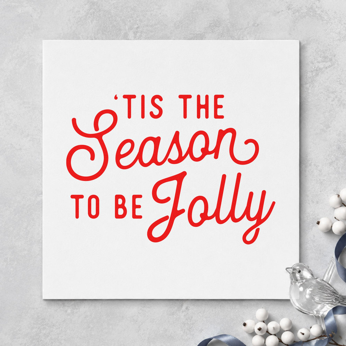 Tis The Season Jolly Script craft stamp in red ink on cardstock, an easy option for tea towel printing.