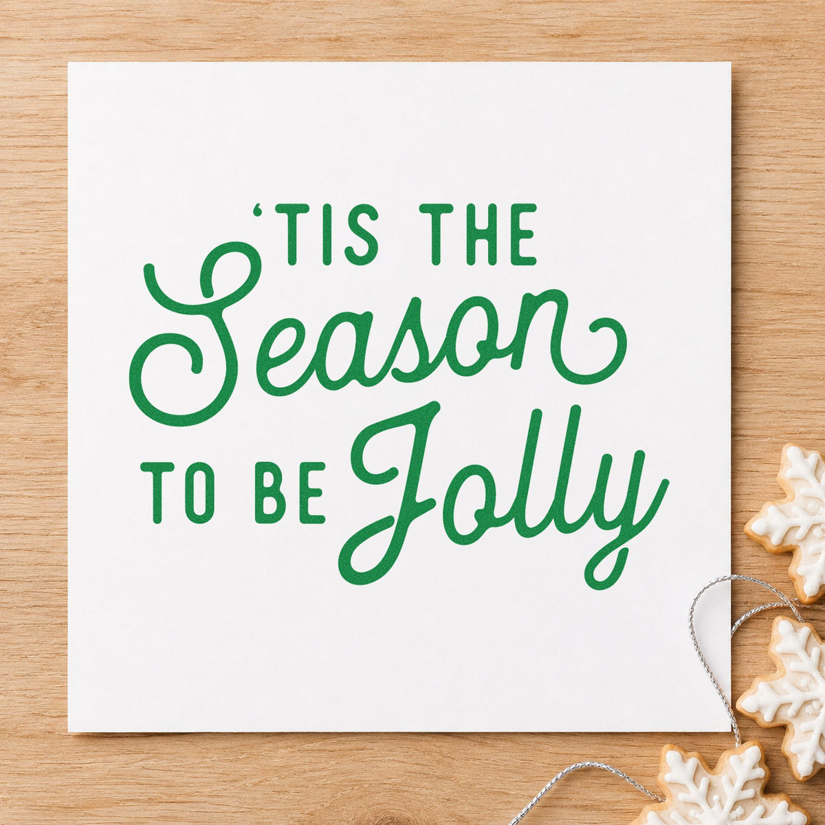 Tis The Season Jolly Script craft stamp imprinted in green ink on paper, a design suited to framed kitchen wall.