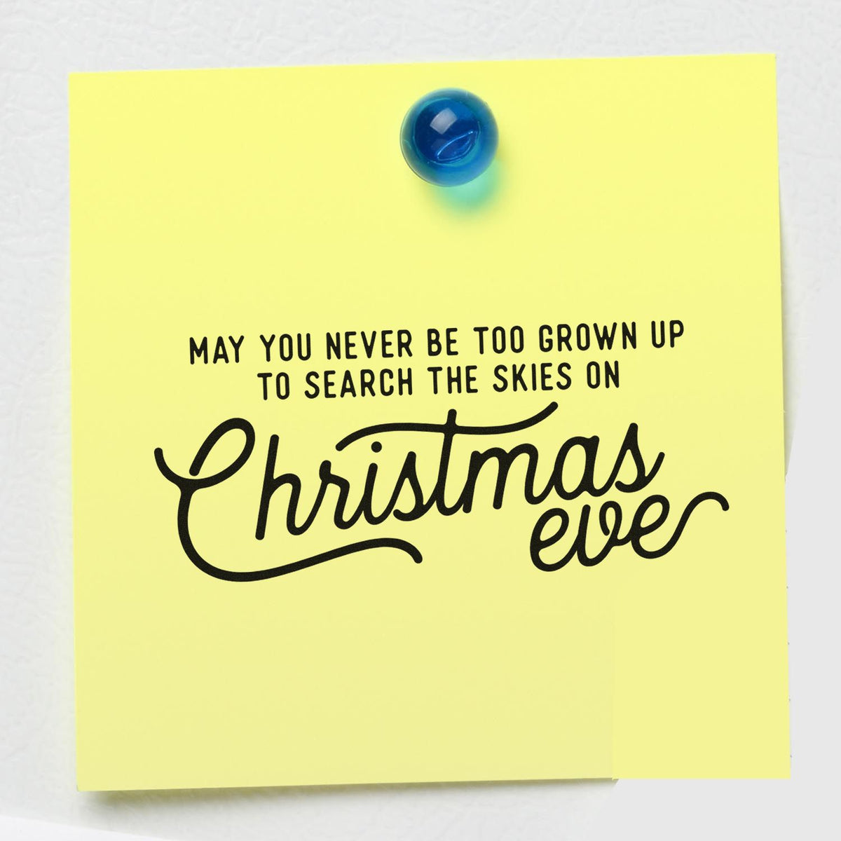 Yellow stamp and seal note with black Christmas Eve quote in bold black and a blue seal pin at top.