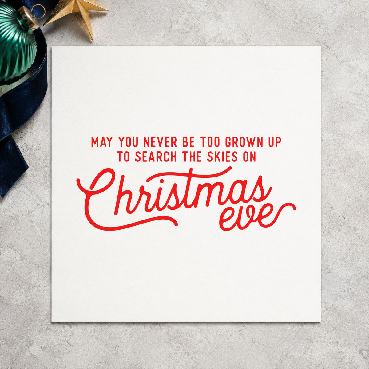 Never Grown Up Christmas Eve rubber stamp shown in red ink, stamped for projects such as lens bin labels.