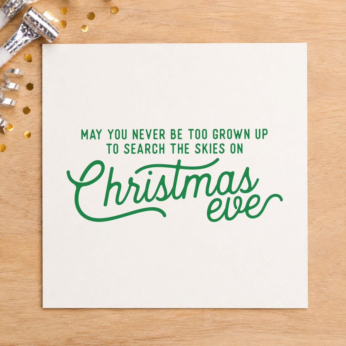 Never Grown Up Christmas Eve craft stamp imprint in green ink on a handmade project, one idea being viewing party cards.