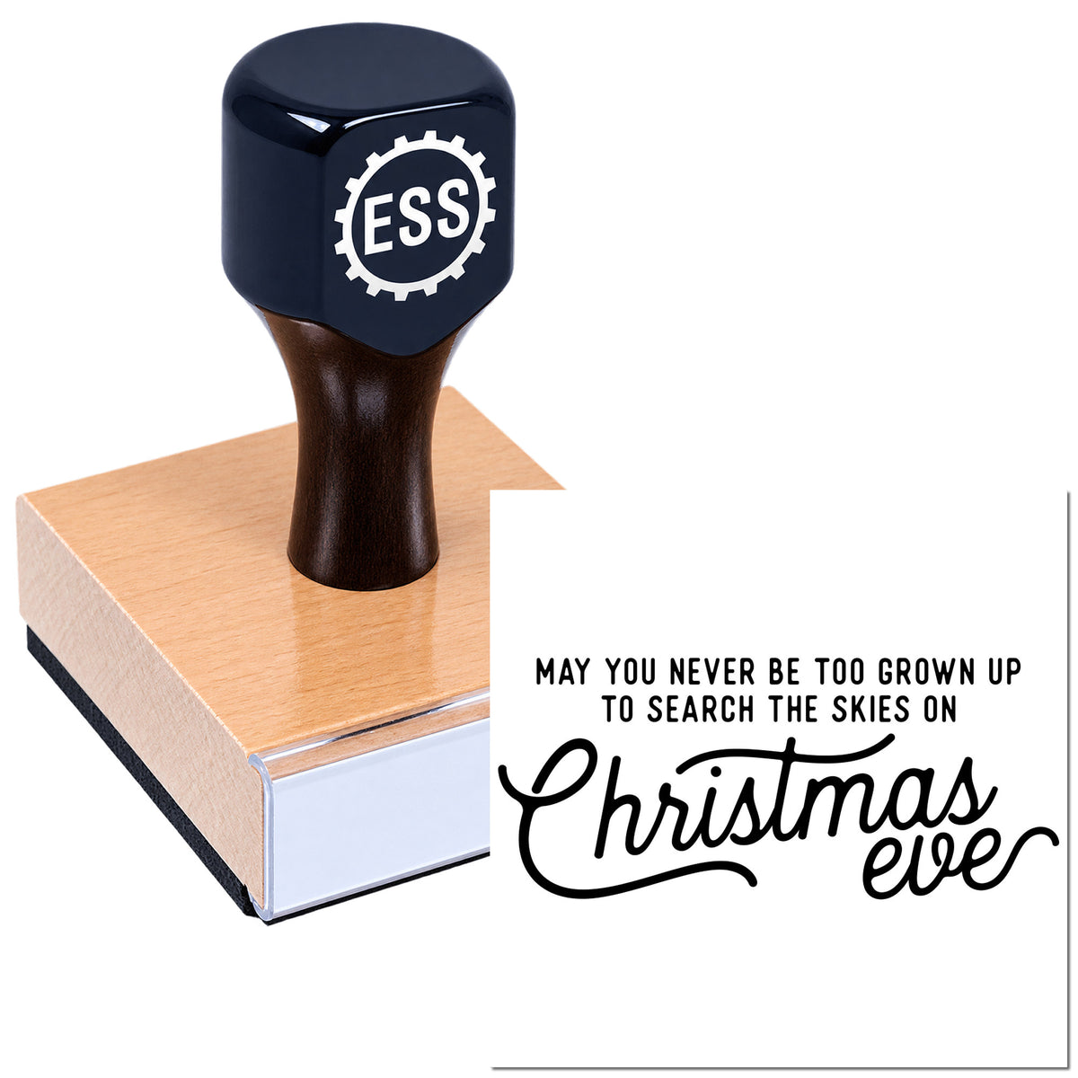 Black ESS rubber stamp seal with rose-gold base beside a white Christmas Eve greeting card.