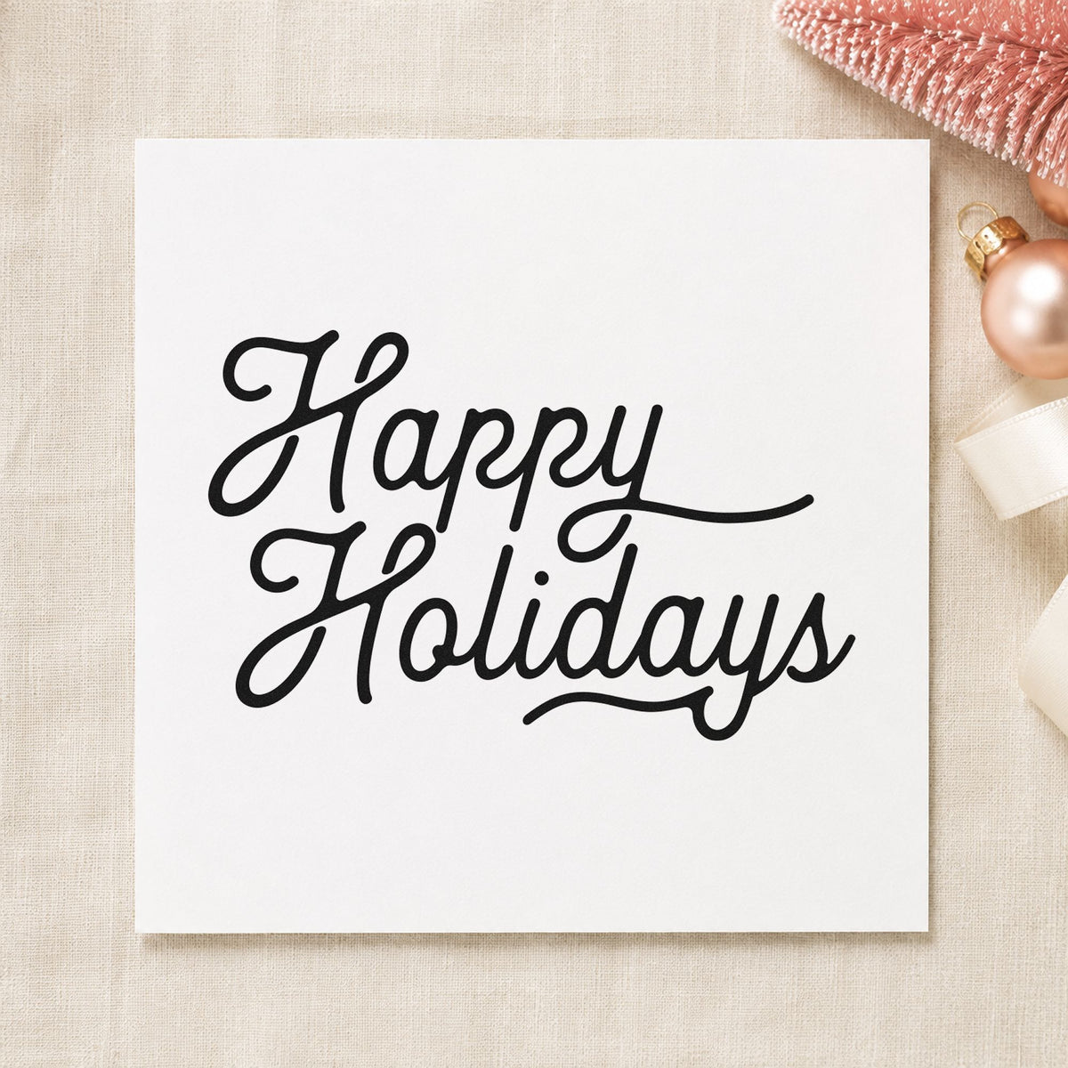 Happy Holidays Flowing Script craft stamp imprint in black ink on a handmade project, one idea being trailing gift tags.