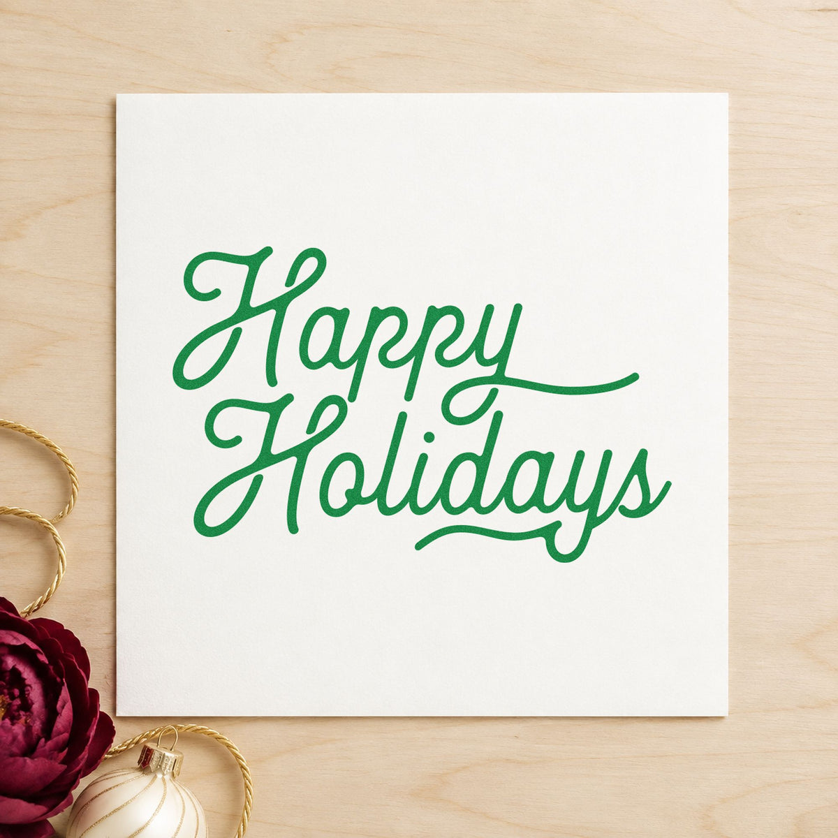 Happy Holidays Flowing Script craft stamp imprinted in green ink on paper, a design suited to framed wide mat.