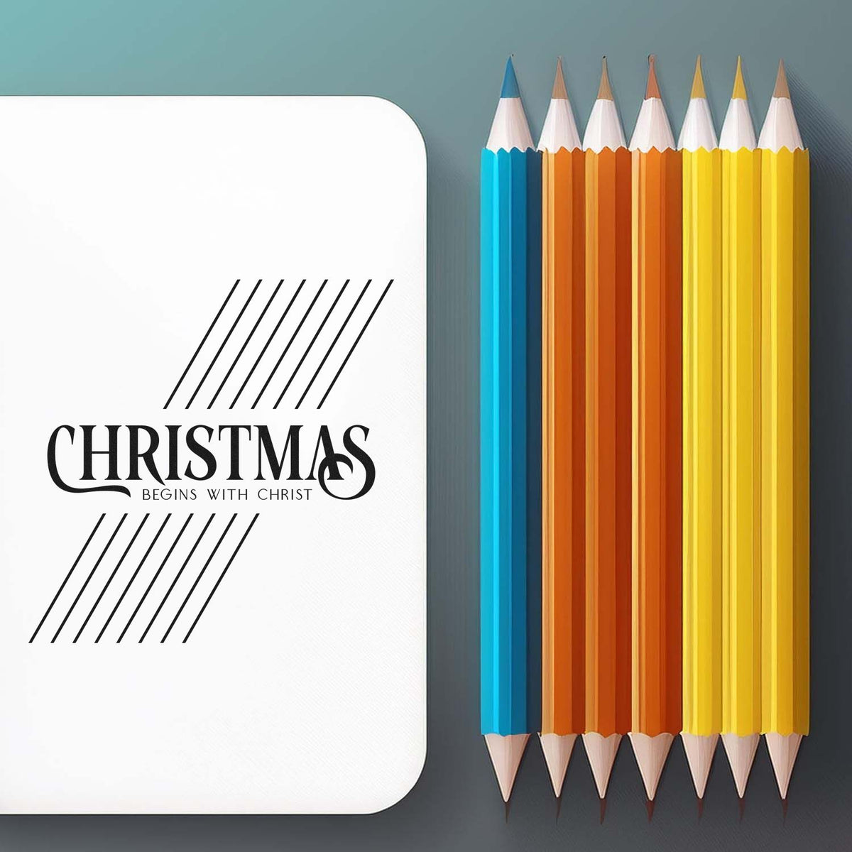 Custom Christmas stamp seal on a white card with black lettering, beside blue, orange, and yellow pencils on a gray background.