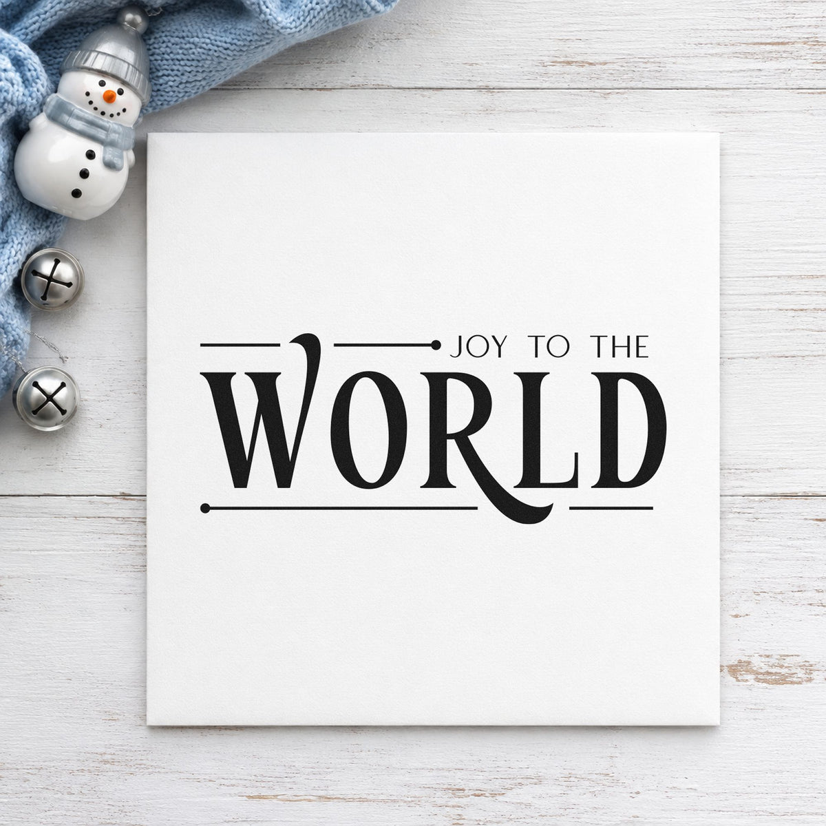 Joy To The World Serif craft stamp imprint in black ink on a handmade project, one idea being end note gift tags.
