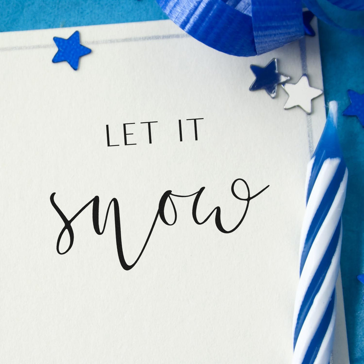 Custom stamp and seal card reading LET IT SHINE, with blue stars, silver star, and blue ribbon on white.