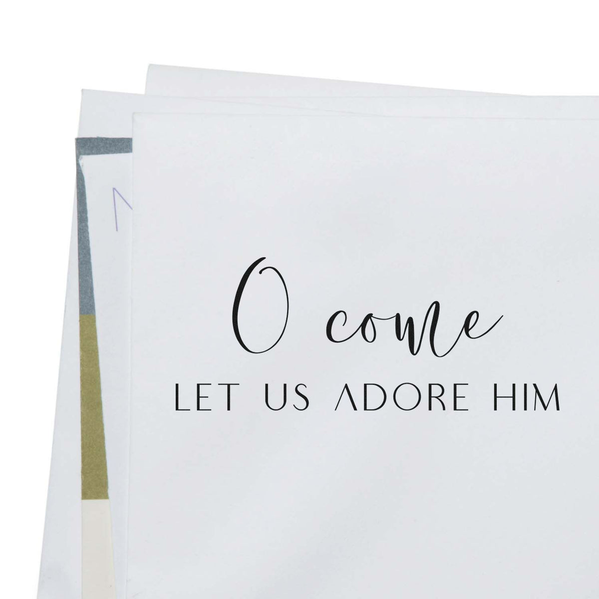 White custom stamp and seal cards with black O come, let us adore him lettering and muted gold-gray accents.