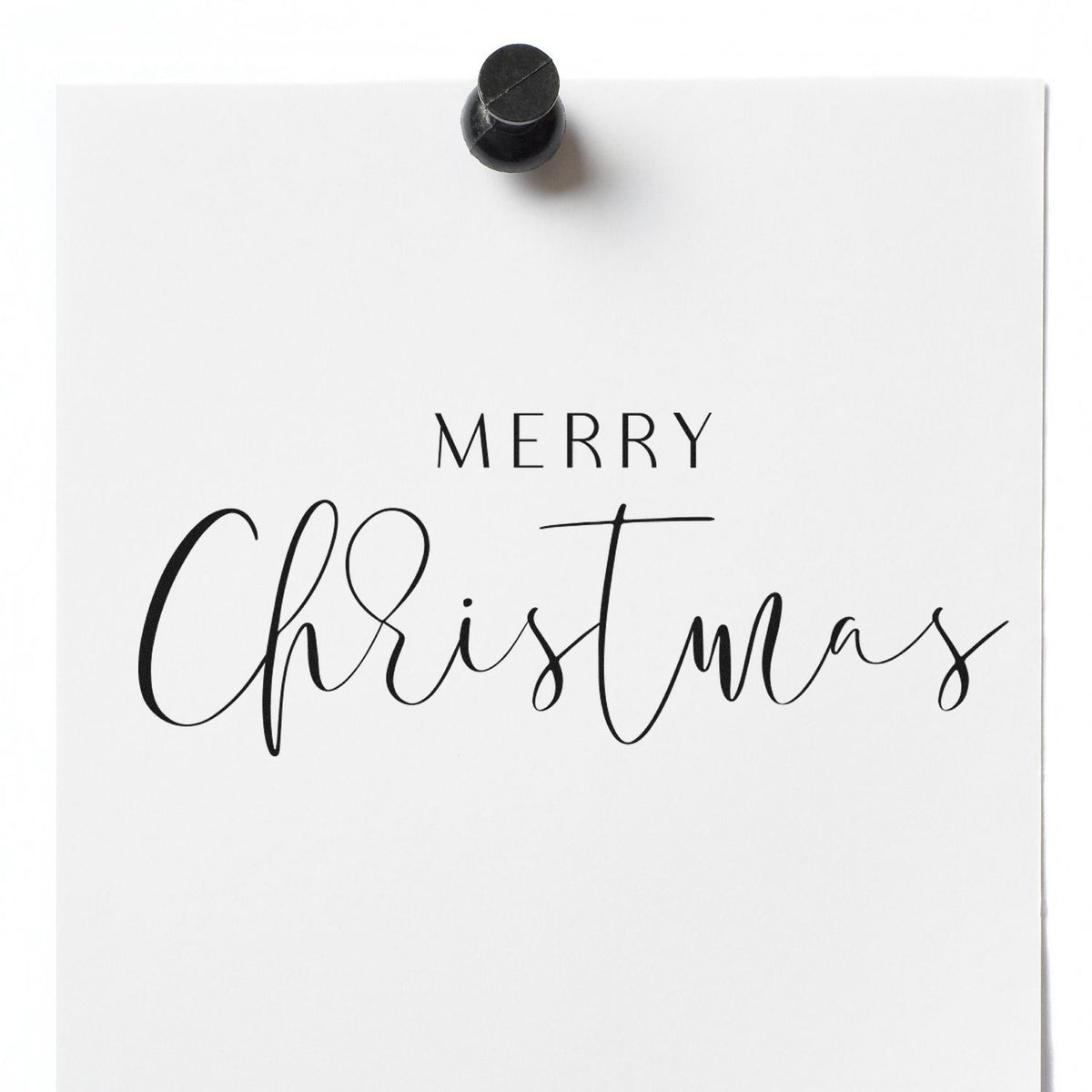 Black stamp seal on white card with Merry Christmas in elegant script