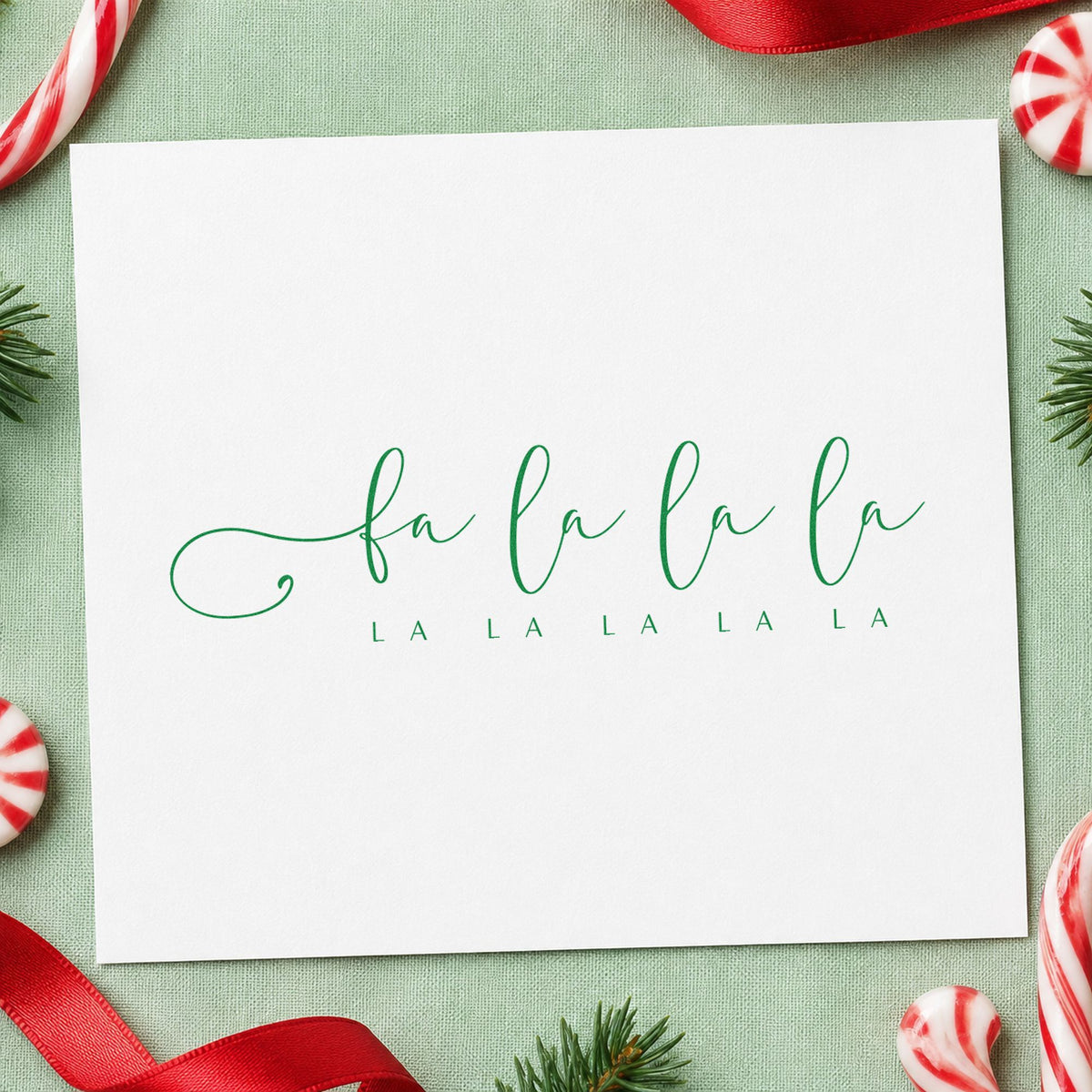 Fa La La Holiday Script craft stamp imprinted in purple ink on paper, a design suited to framed piano ledge.