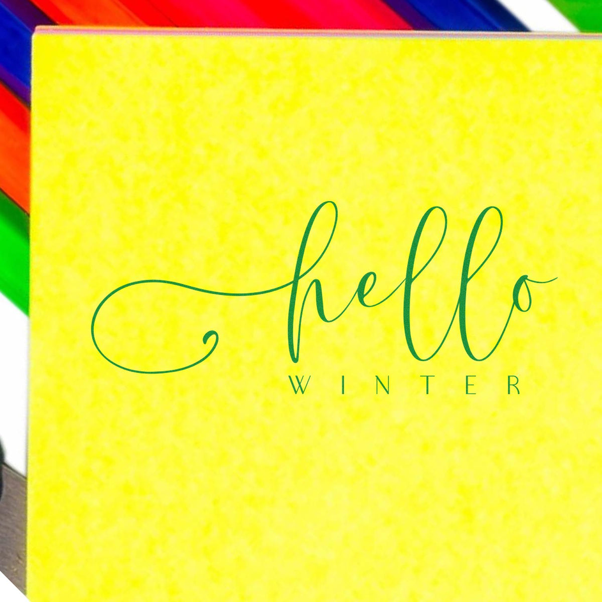 Bright yellow Hello Winter stamp and seal package with green script lettering and rainbow-colored accents.