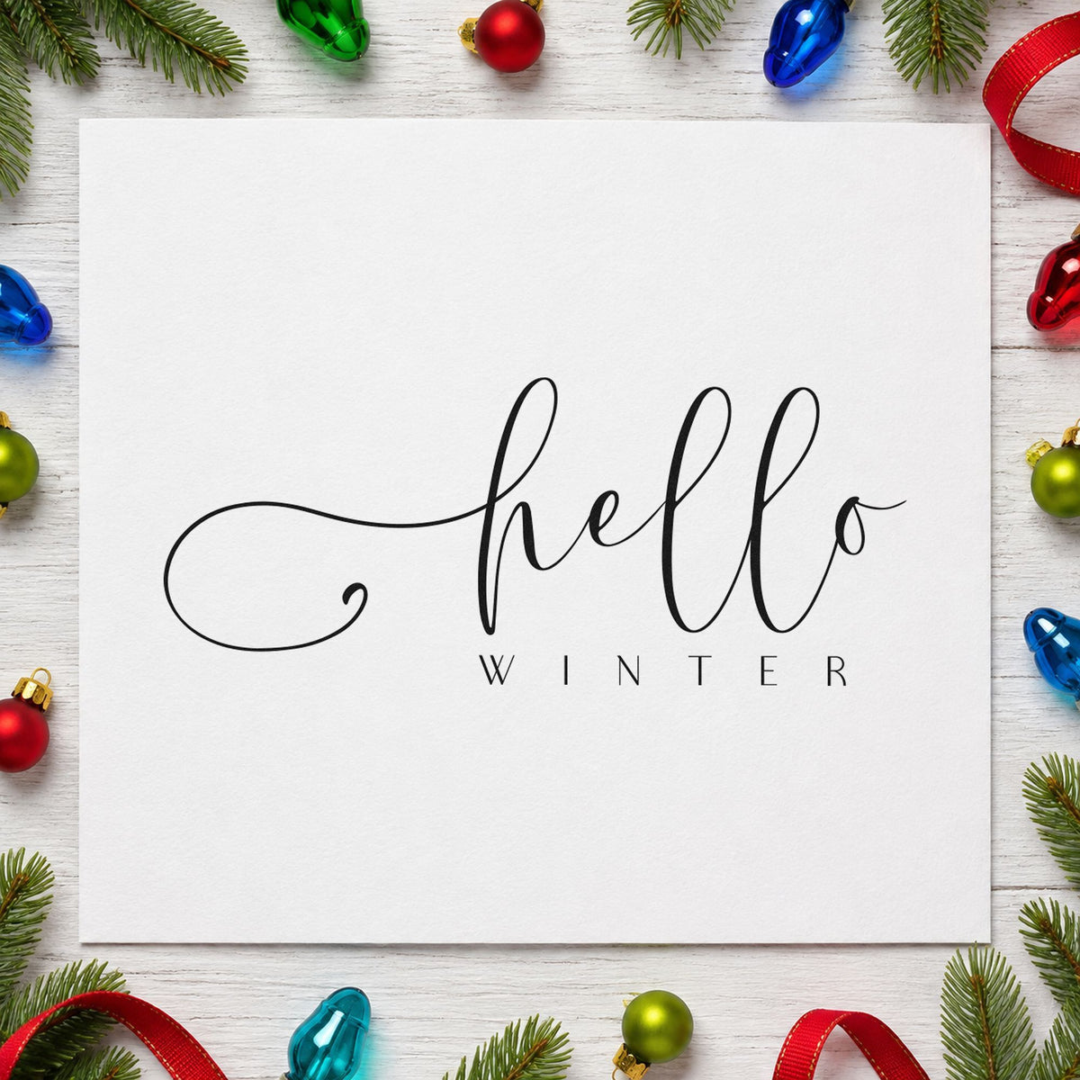 Hello Winter Fine Script craft stamp imprint in black ink on a handmade project, one idea being plain stock tags.