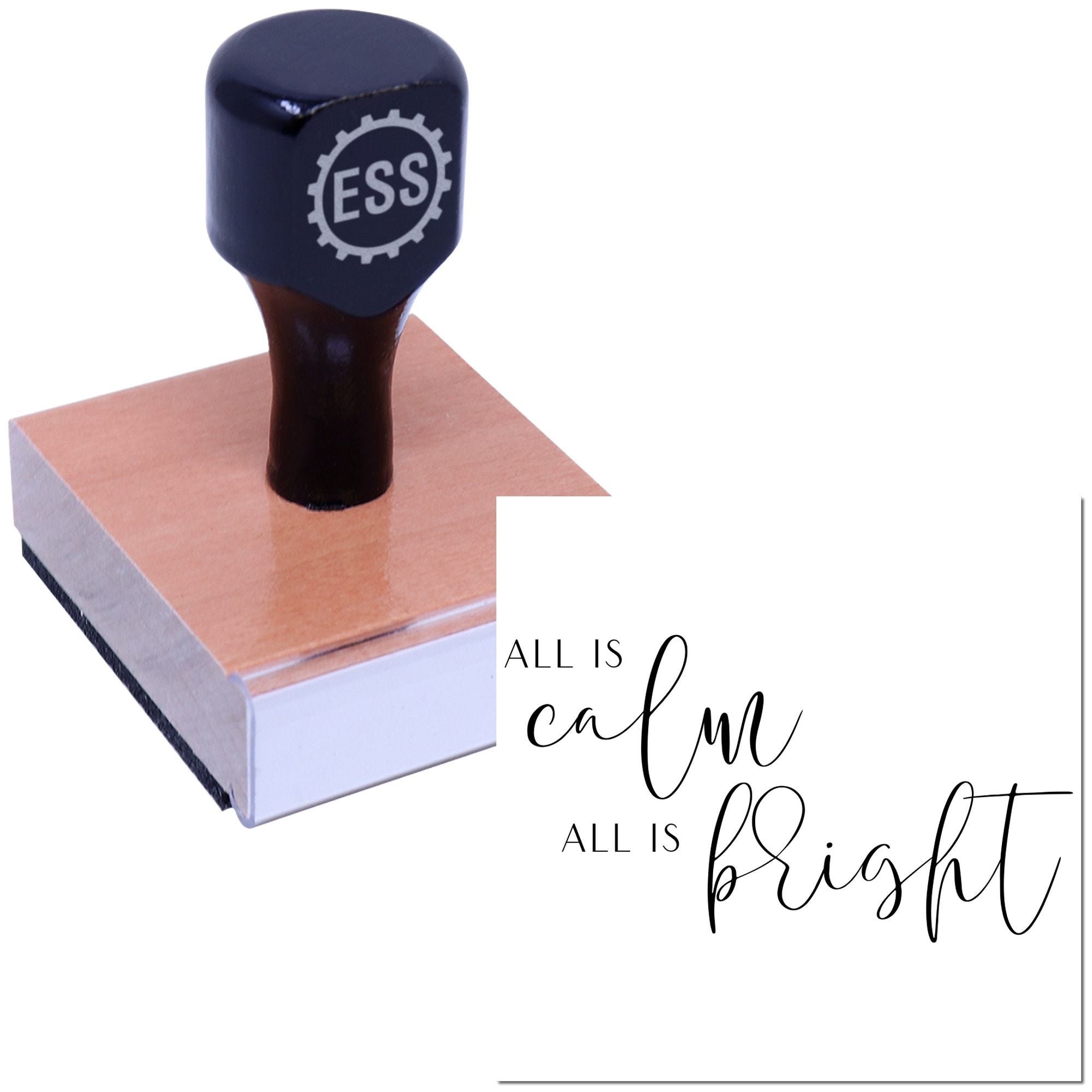Dark navy ESS stamp seal on a pink wooden block beside All is calm, all is bright script