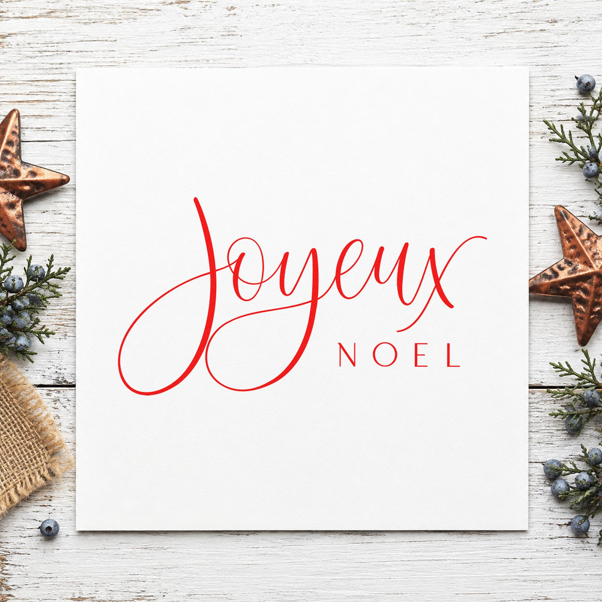 Joyeux Noel Fine Script craft stamp in red ink on cardstock, an easy option for linen napkin printing.