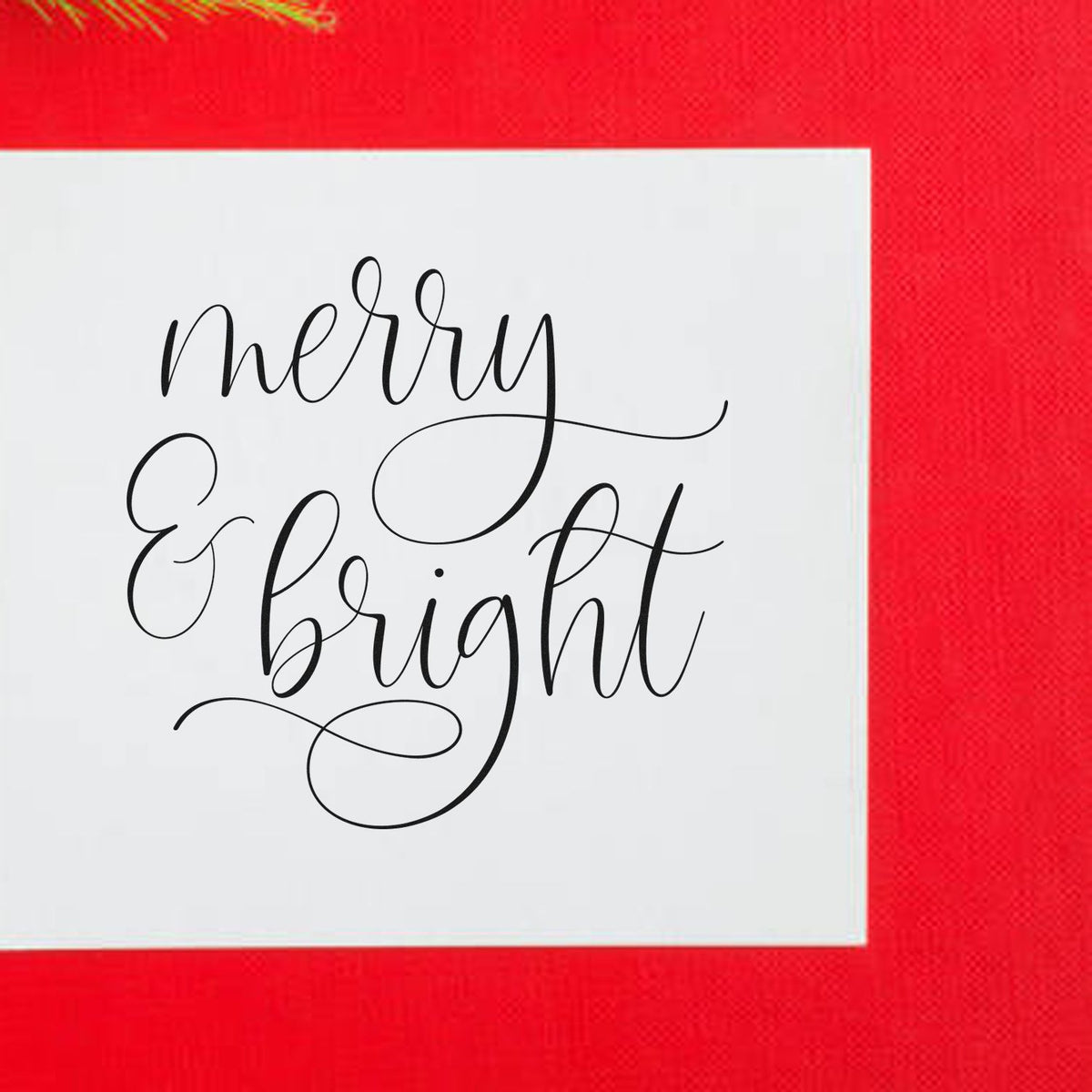 Merry & Bright black script stamp seal on a white square, set against a bright red background.
