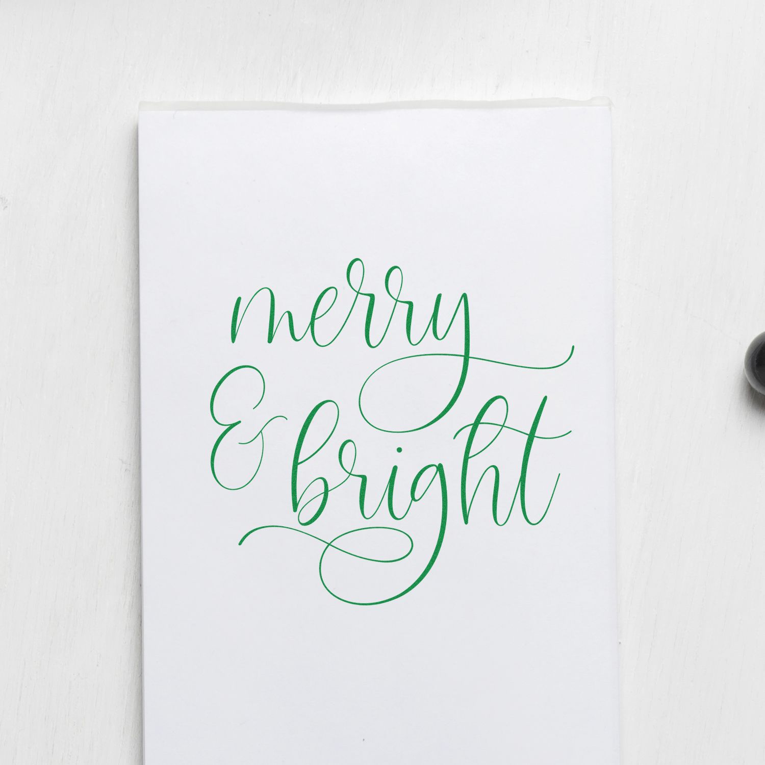 Green Merry & Bright calligraphy stamp and seal on white paper