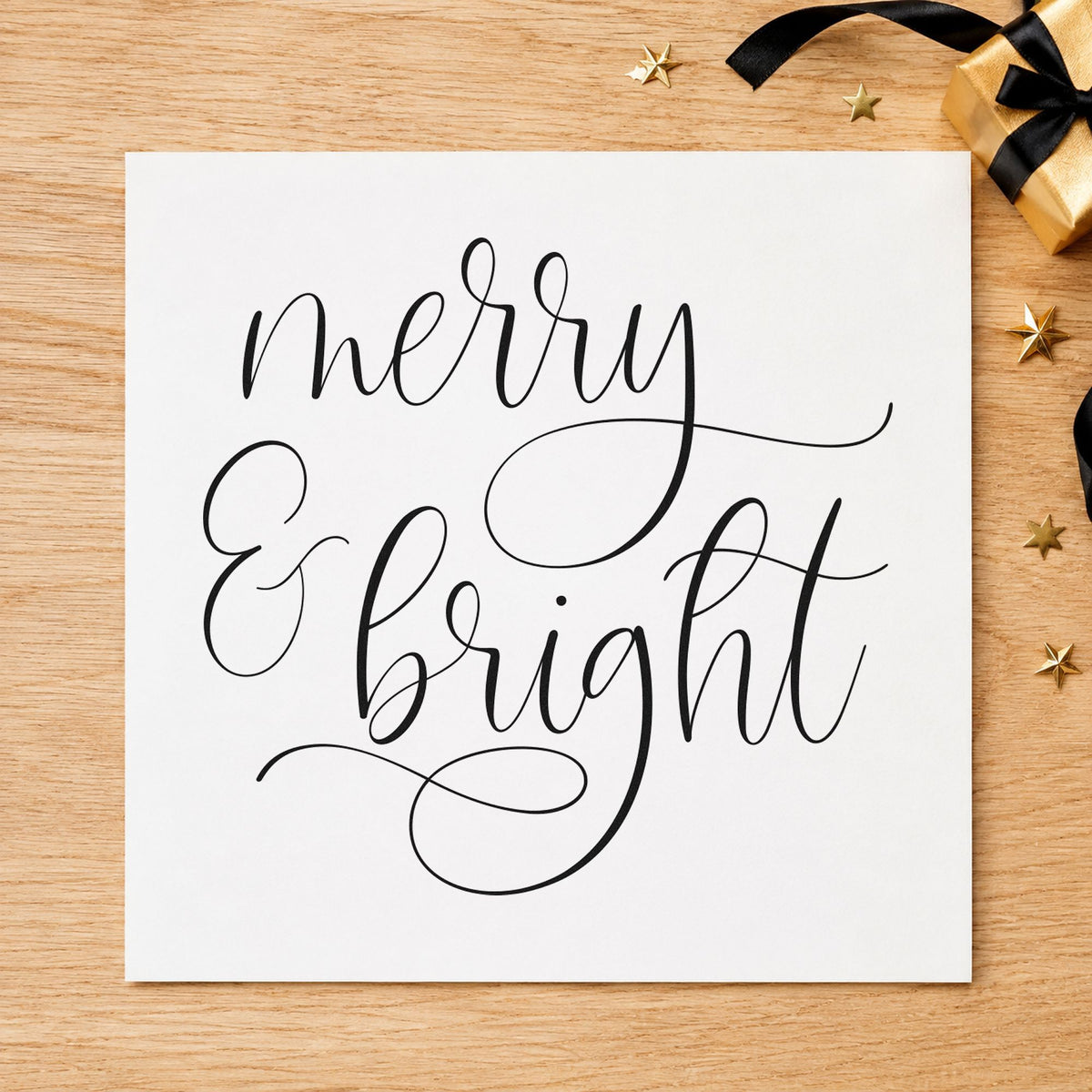 Merry And Bright Looped Script craft stamp imprint in black ink on a handmade project, one idea being addressed gift tags.