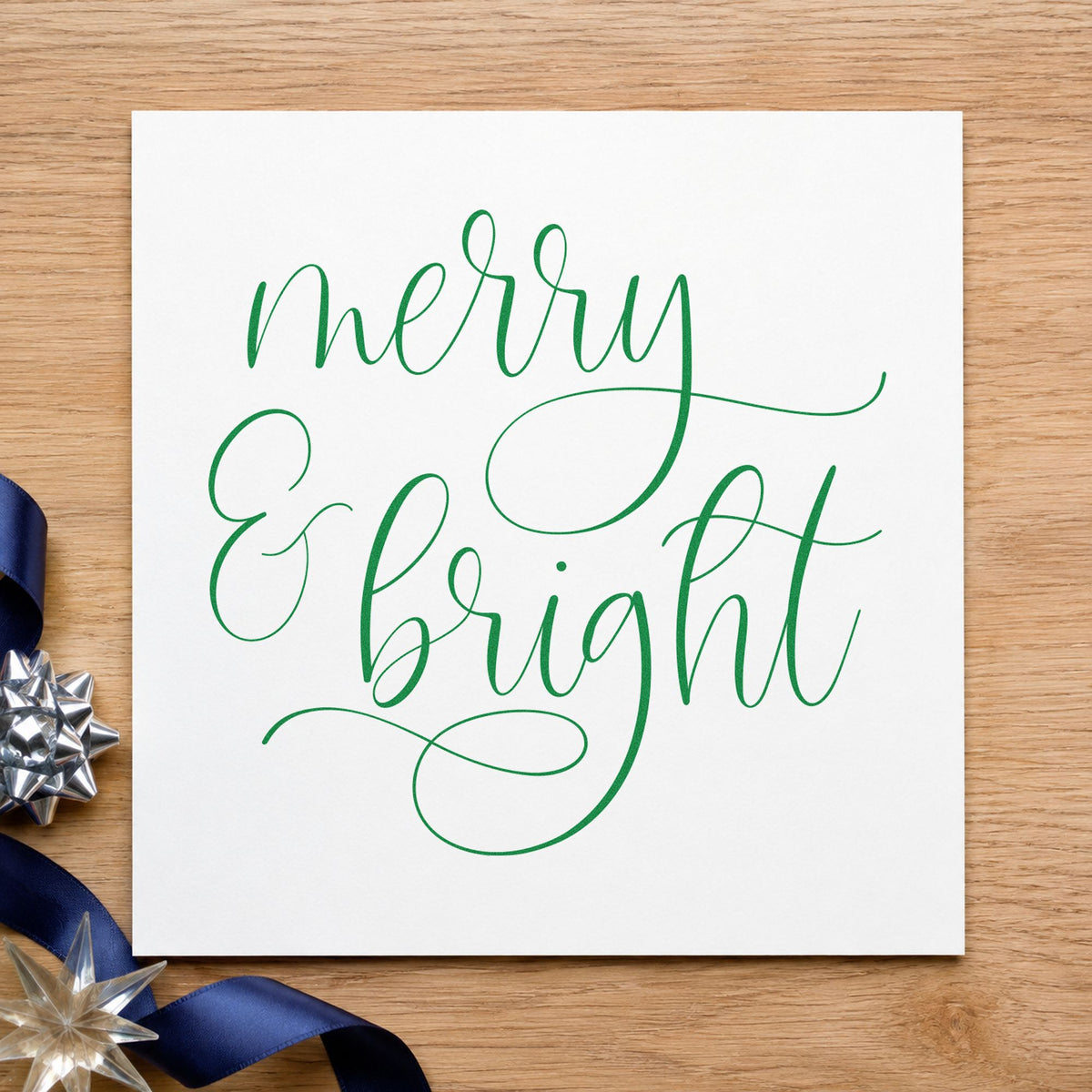 Merry And Bright Looped Script craft stamp imprint in green ink on a handmade project, one idea being class handout slips.