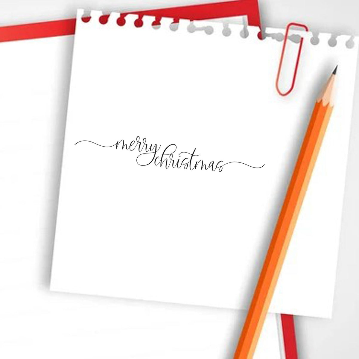 Merry Christmas calligraphy stamp and seal design on white paper, with red accents, pencil, and paperclip.