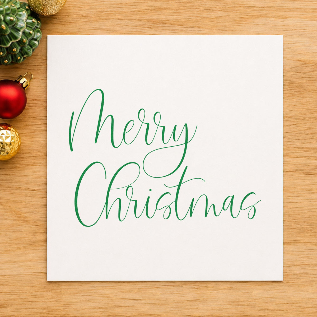 Merry Christmas Airy Calligraphy craft stamp in green ink on cardstock, an easy option for open album page.