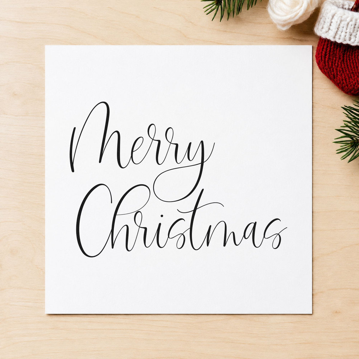 Merry Christmas Airy Calligraphy craft stamp imprint in black ink on a handmade project, one idea being light stock tags.