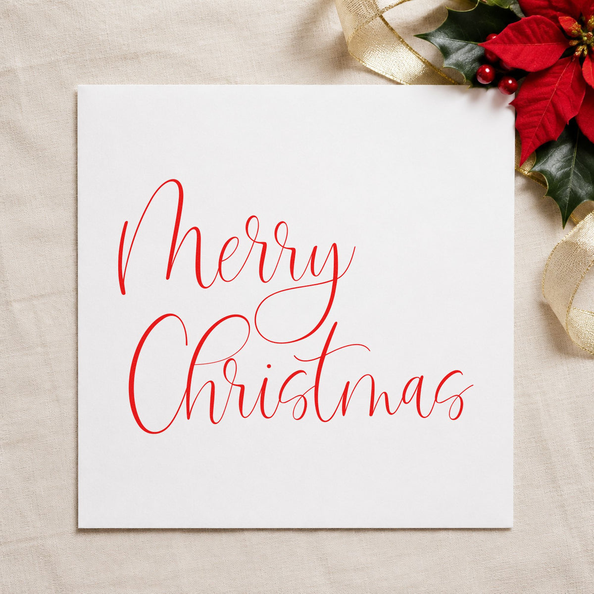 Merry Christmas Airy Calligraphy craft stamp in red ink on cardstock, an easy option for linen corner printing.
